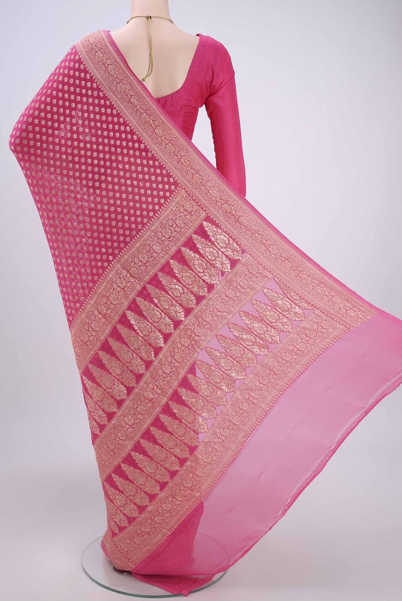 Flat view of Rani Pink Banarasi Georgette Saree with Zari Butta on the body and Zari Border. 