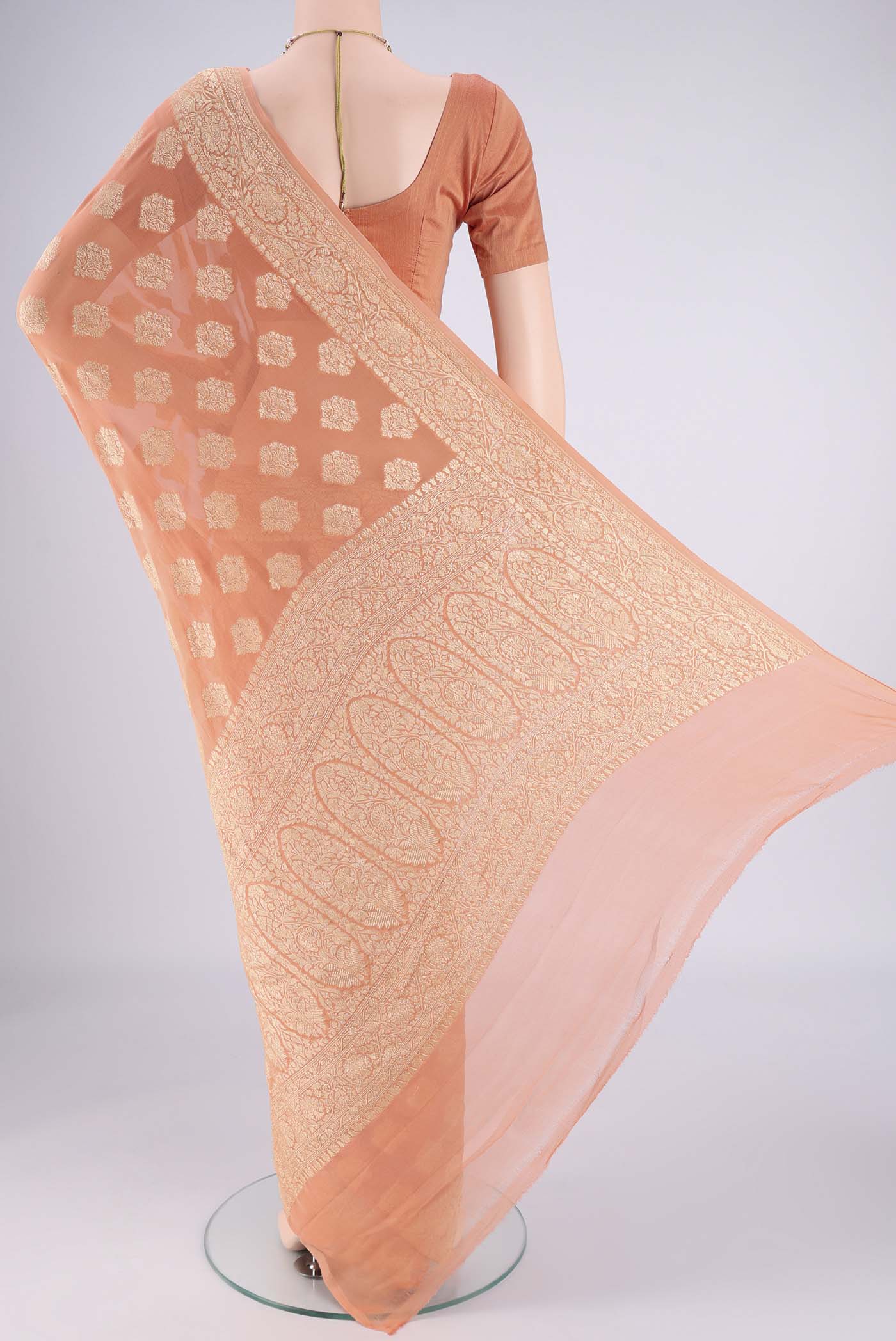 Flat view of Peach Banarasi Georgette Saree with Zari Butta on the body and Zari Border. 
