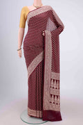 Maroon Banarasi Georgette Saree with Zari Butta on the body and Zari Border.  displayed on a mannequin