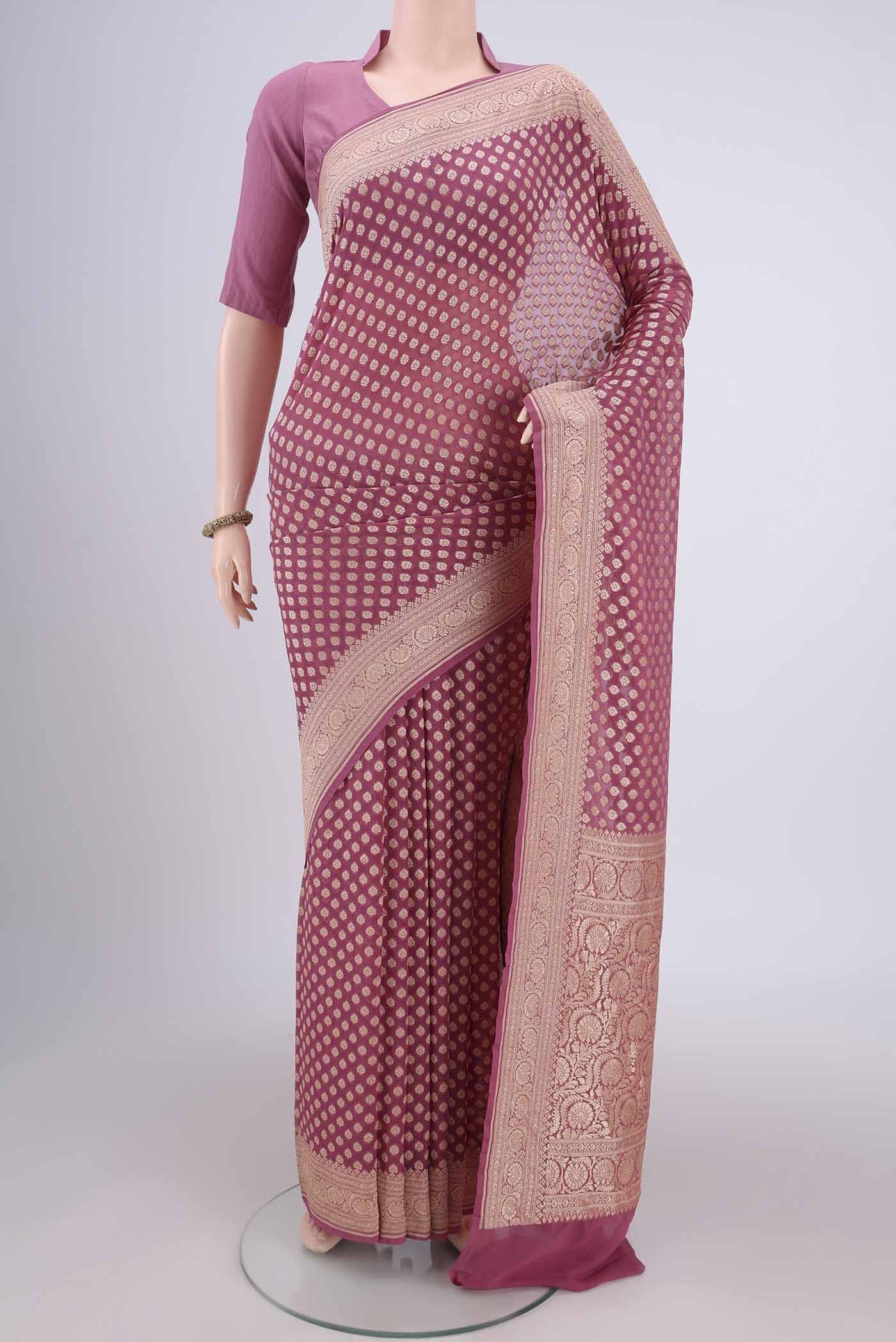 Rose Gold Banarasi Georgette Saree with Zari Brocade on the body and Zari Border.  displayed on a mannequin