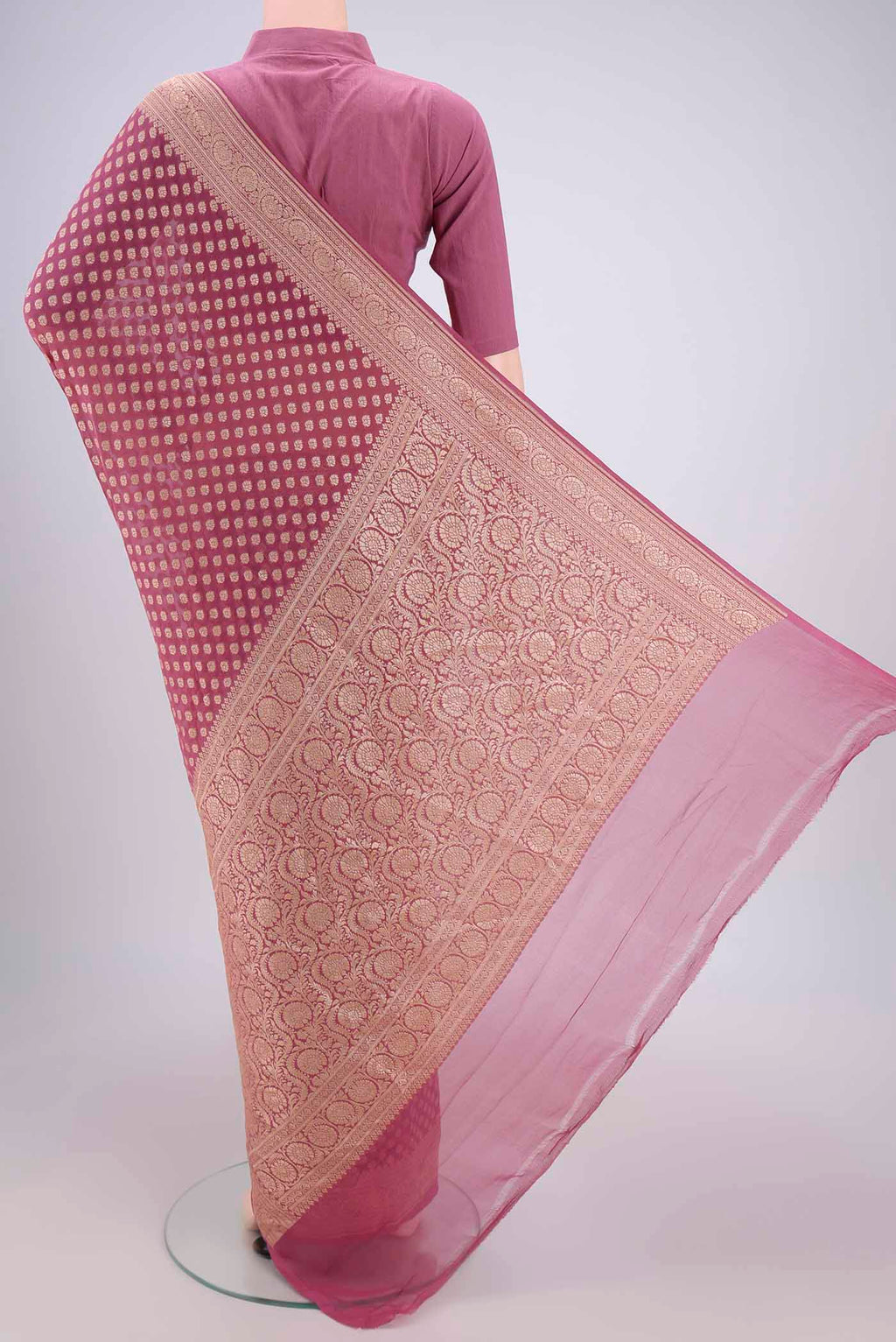 Flat view of Rose Gold Banarasi Georgette Saree with Zari Brocade on the body and Zari Border. 