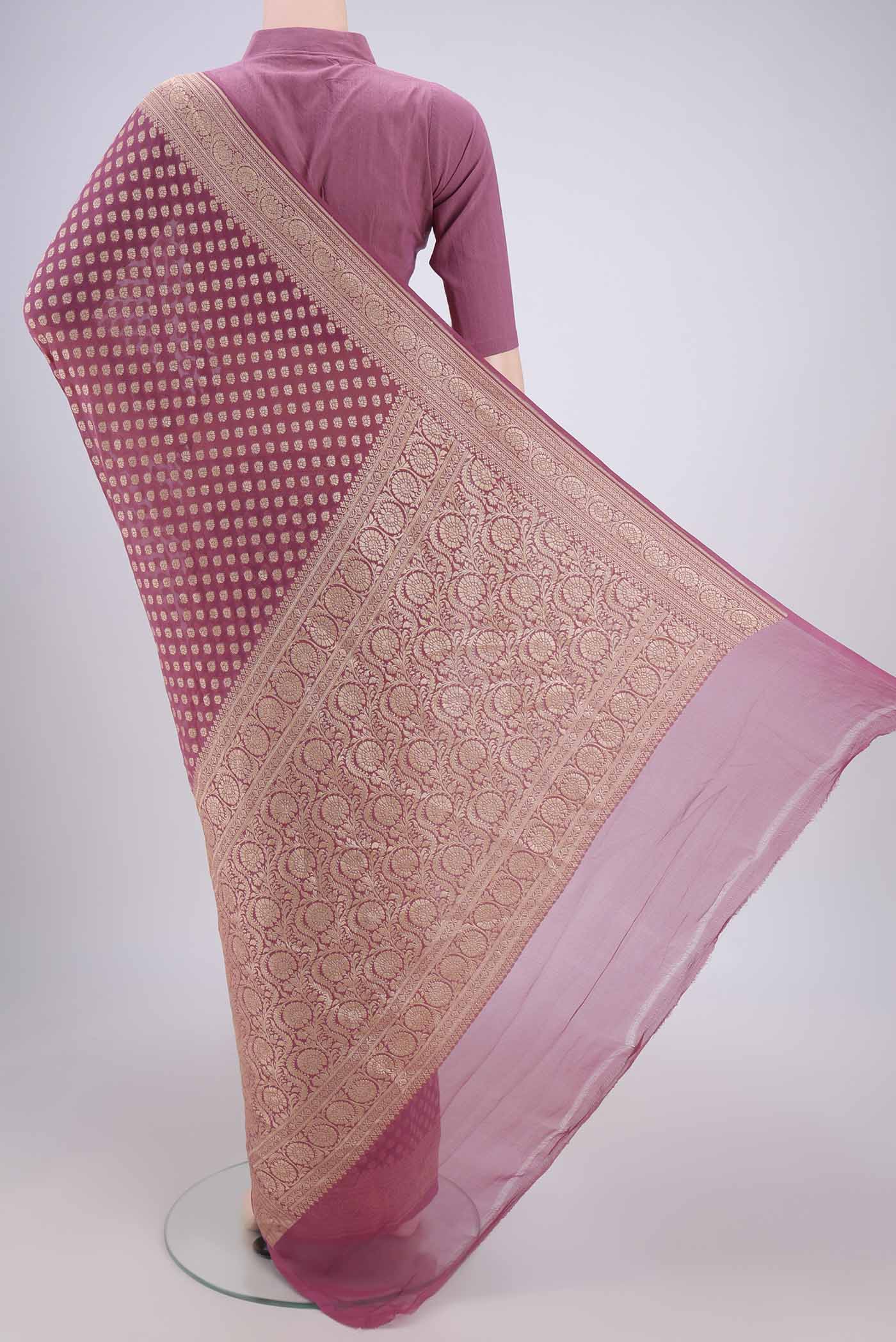 Flat view of Rose Gold Banarasi Georgette Saree with Zari Brocade on the body and Zari Border. 