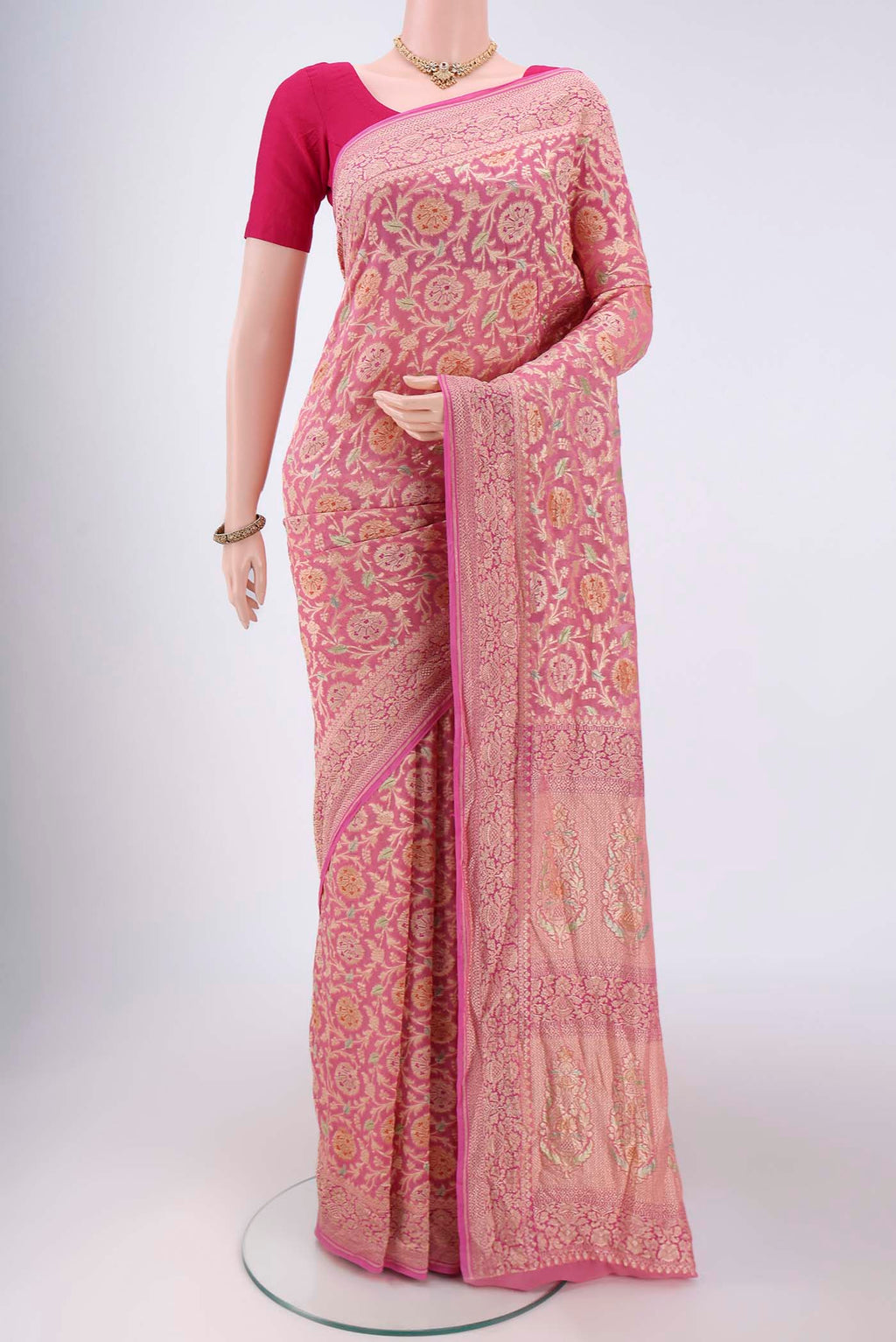 Pink Banarasi Georgette Saree with Zari Brocade on the body and Zari Border.  displayed on a mannequin