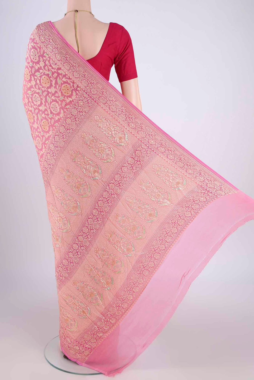 Flat view of Pink Banarasi Georgette Saree with Zari Brocade on the body and Zari Border. 