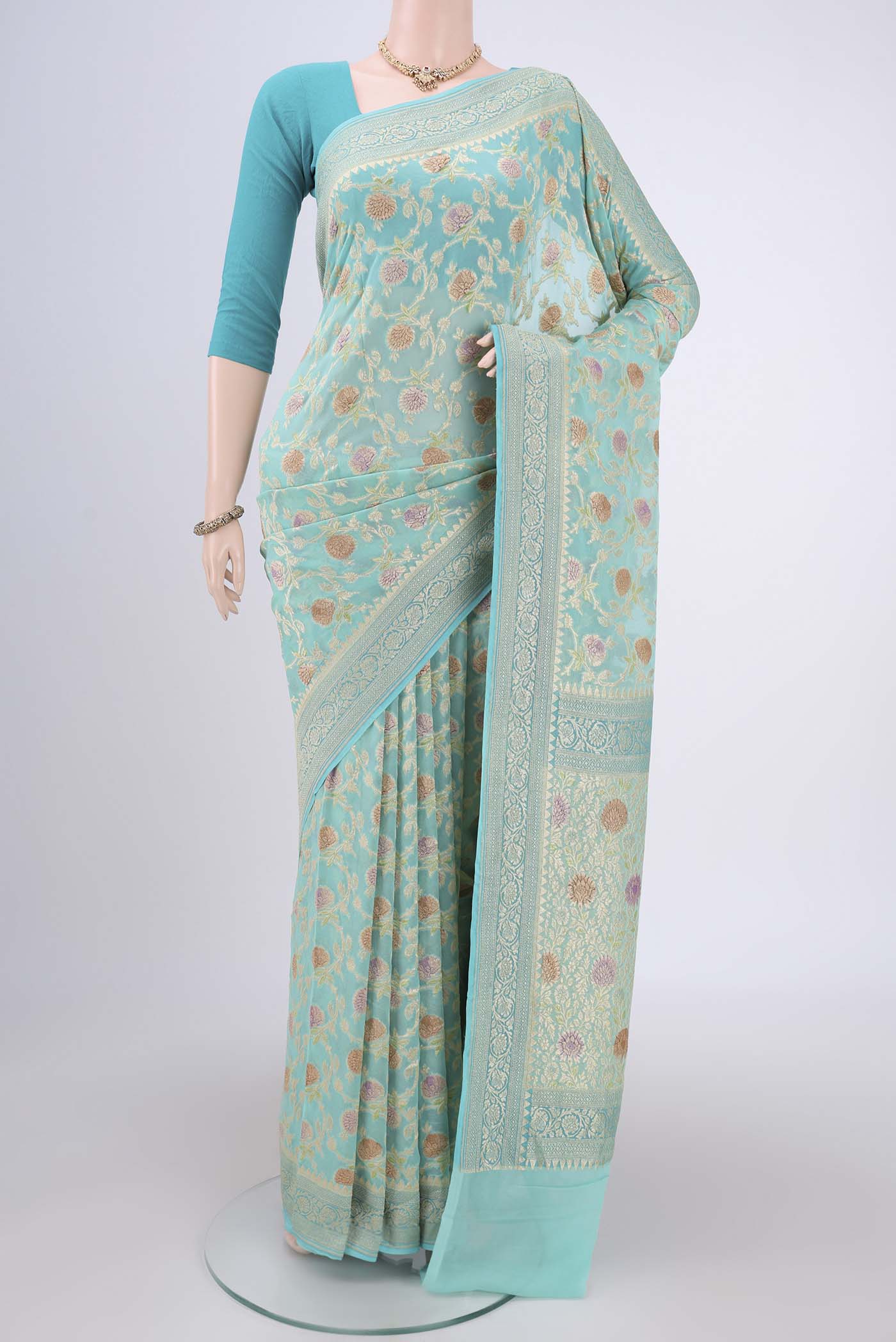 Sea Green Banarasi Georgette Saree with Zari Brocade on the body and Zari Border.  displayed on a mannequin