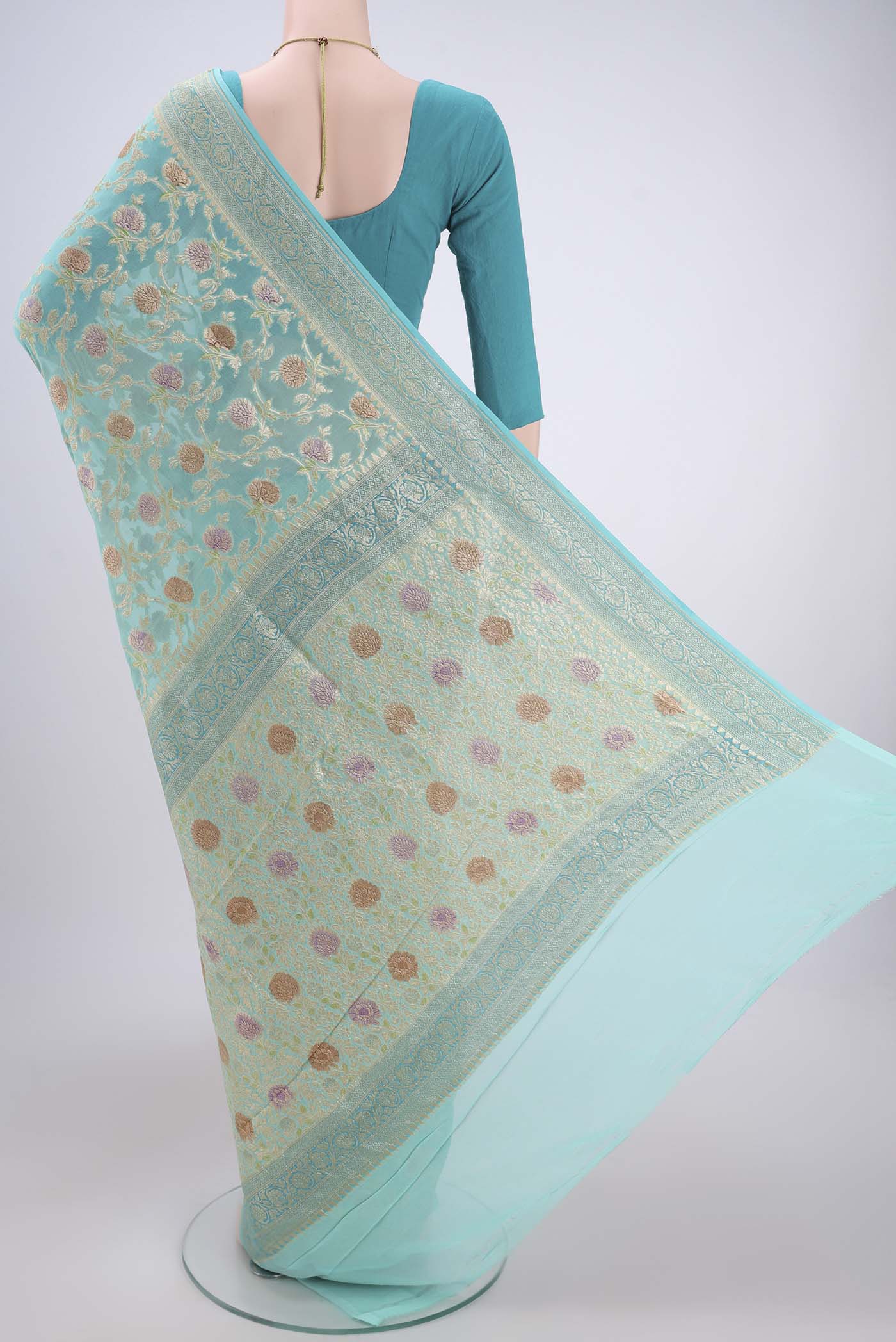 Flat view of Sea Green Banarasi Georgette Saree with Zari Brocade on the body and Zari Border. 