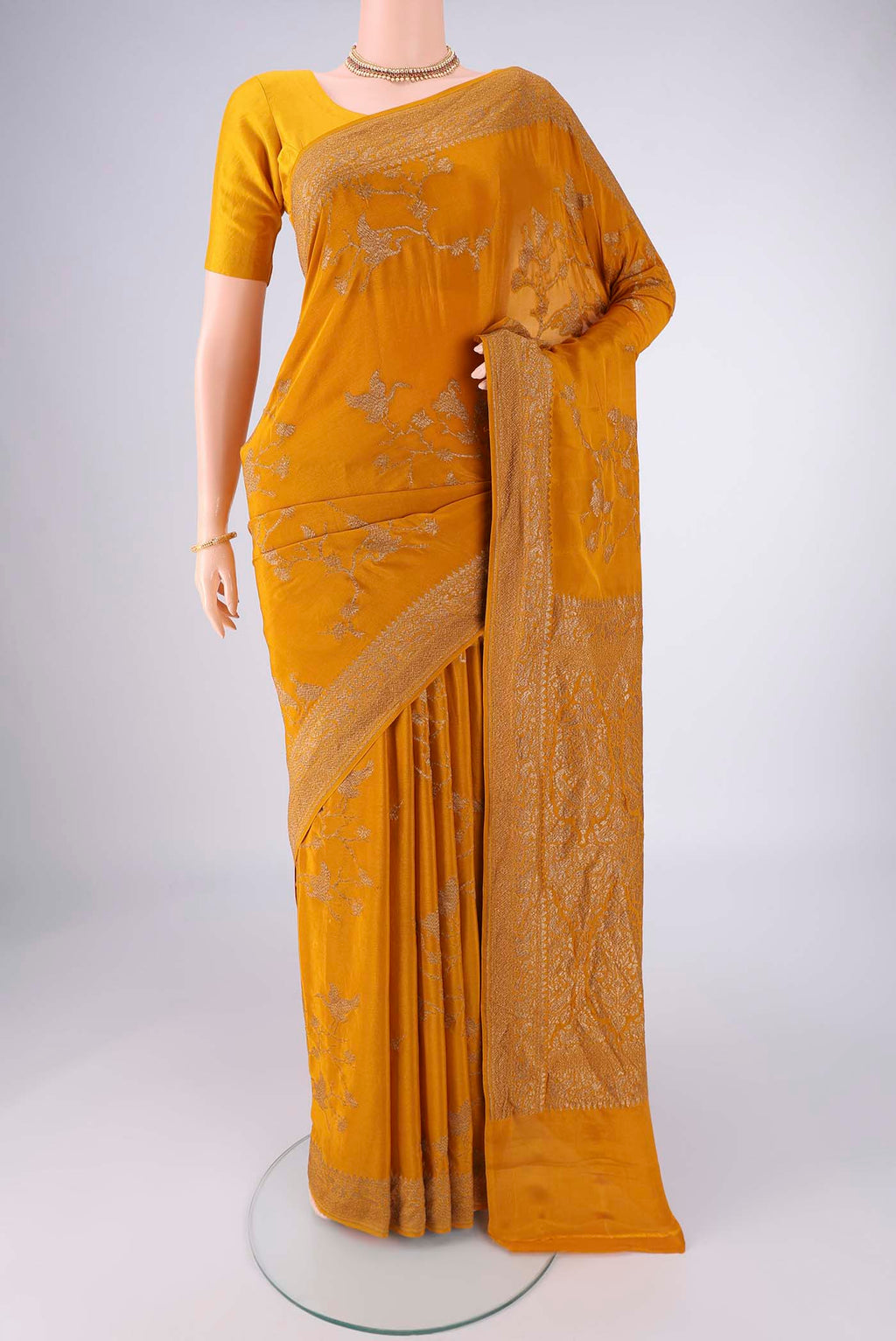 Mustard Banarasi Georgette Saree with Zari Brocade on the body and Zari Border.  displayed on a mannequin