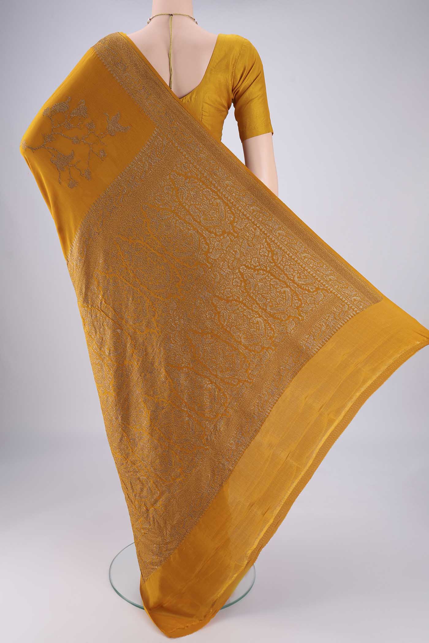Flat view of Mustard Banarasi Georgette Saree with Zari Brocade on the body and Zari Border. 