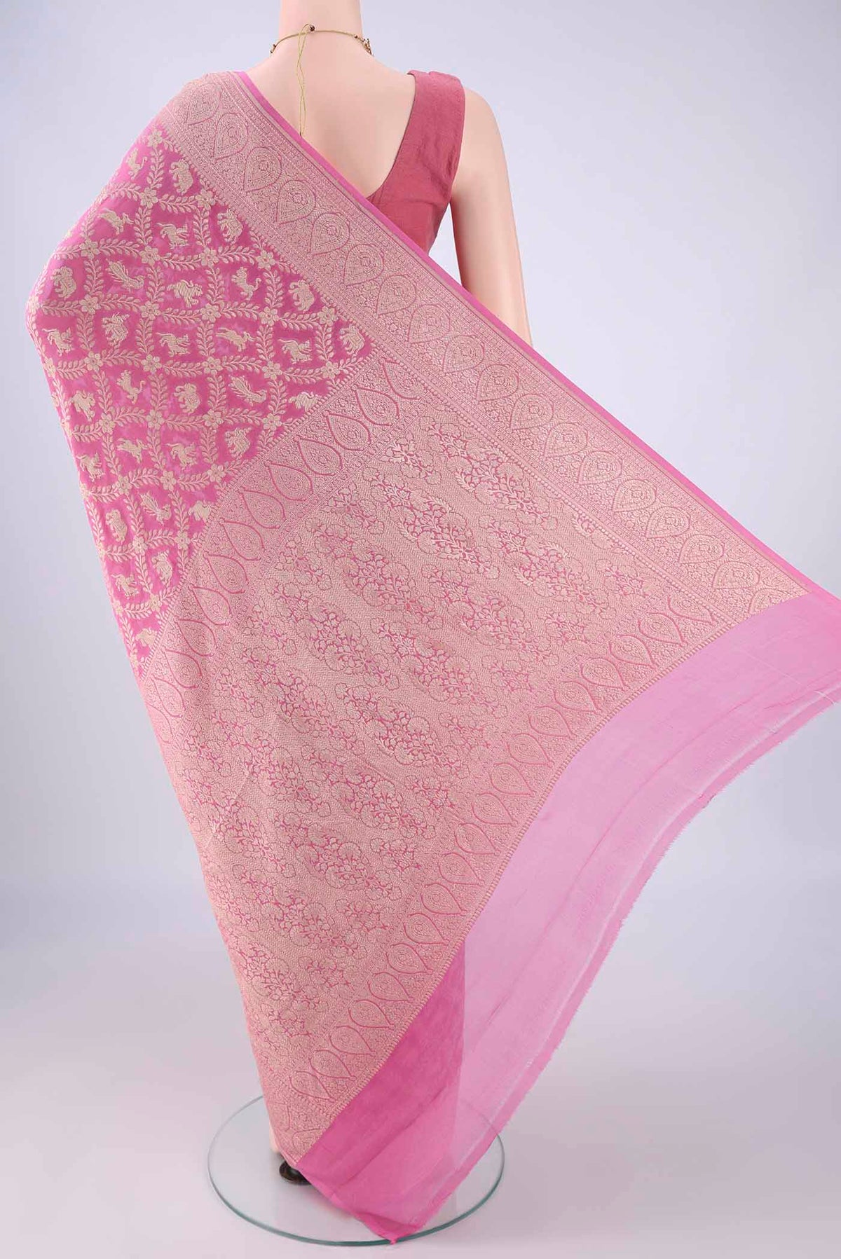 Flat view of Rose pink Banarasi Georgette Saree with Zari Brocade on the body and Zari Border. 