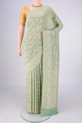 Sage Green Banarasi Georgette Saree with Zari Brocade on the body and Zari Border.  displayed on a mannequin