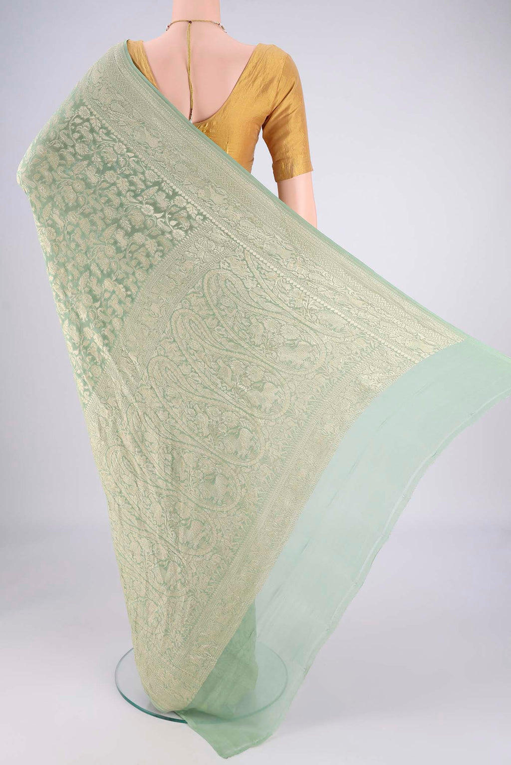 Flat view of Sage Green Banarasi Georgette Saree with Zari Brocade on the body and Zari Border. 