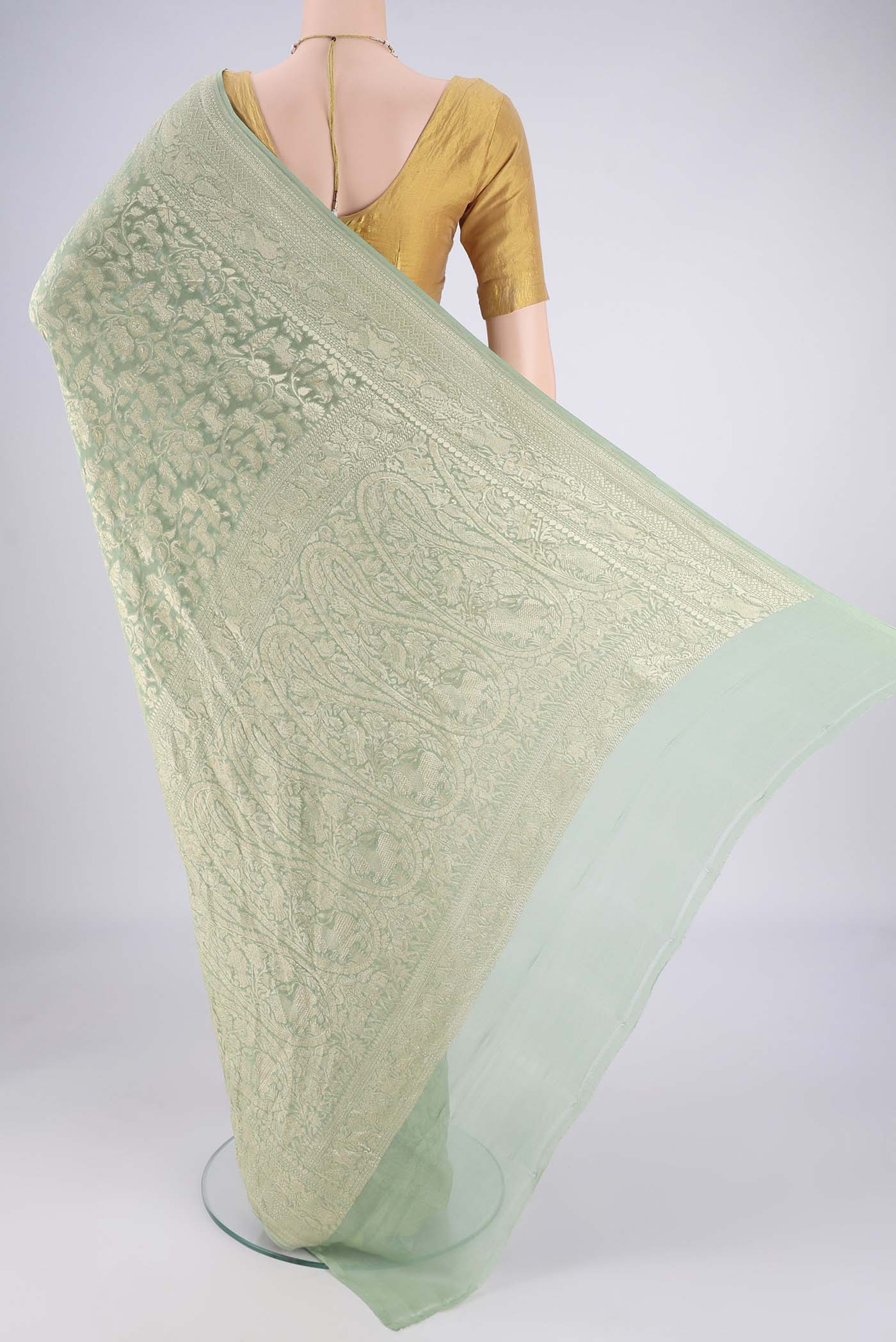 Flat view of Sage Green Banarasi Georgette Saree with Zari Brocade on the body and Zari Border. 