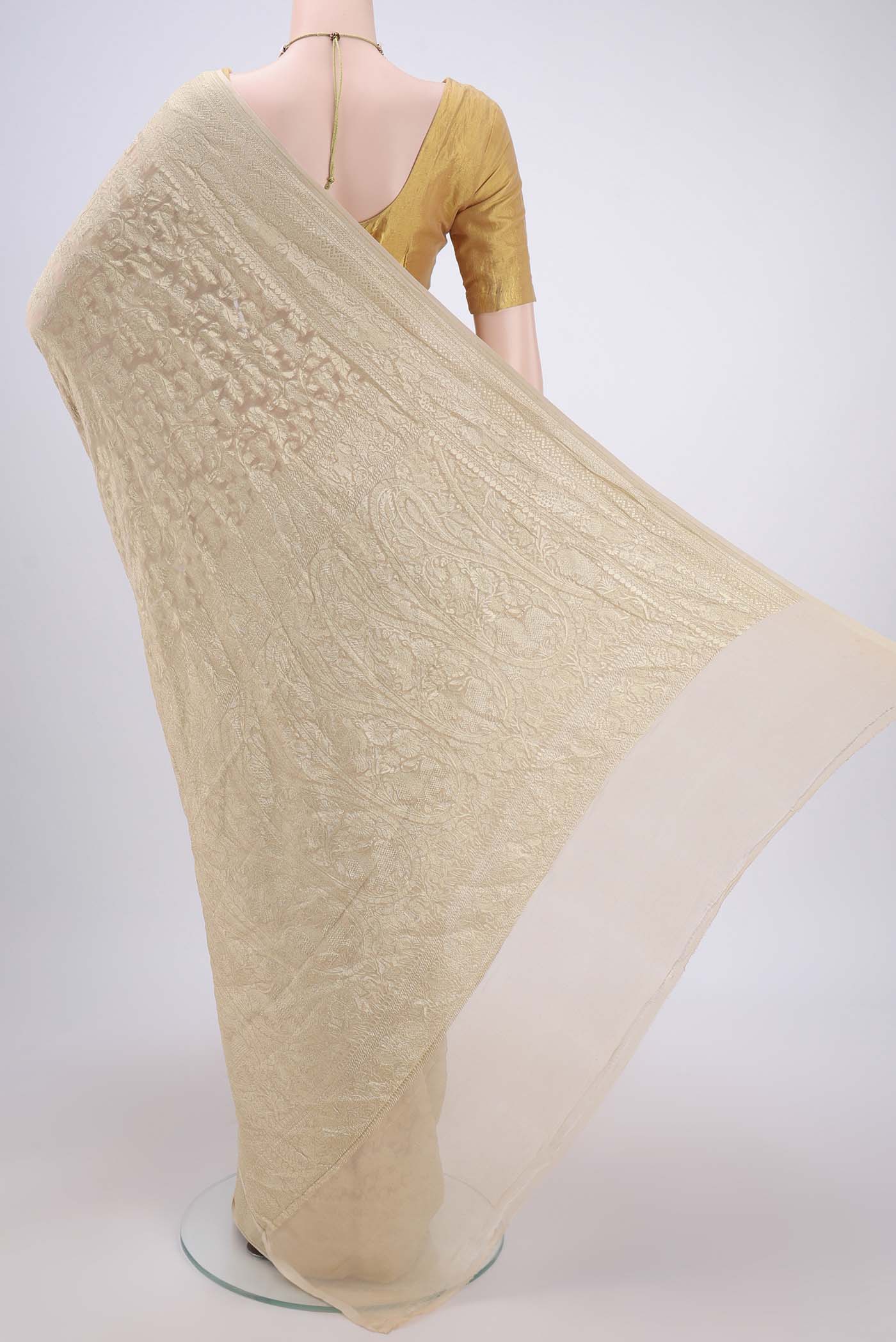 Flat view of Beige Banarasi Georgette Saree with Zari Brocade on the body and Zari Border. 