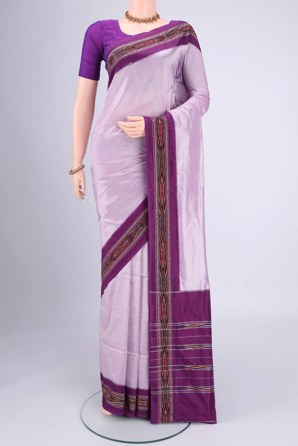 Lilac Pochampally Silk Saree with Plain Body and Ikat Border.  displayed on a mannequin