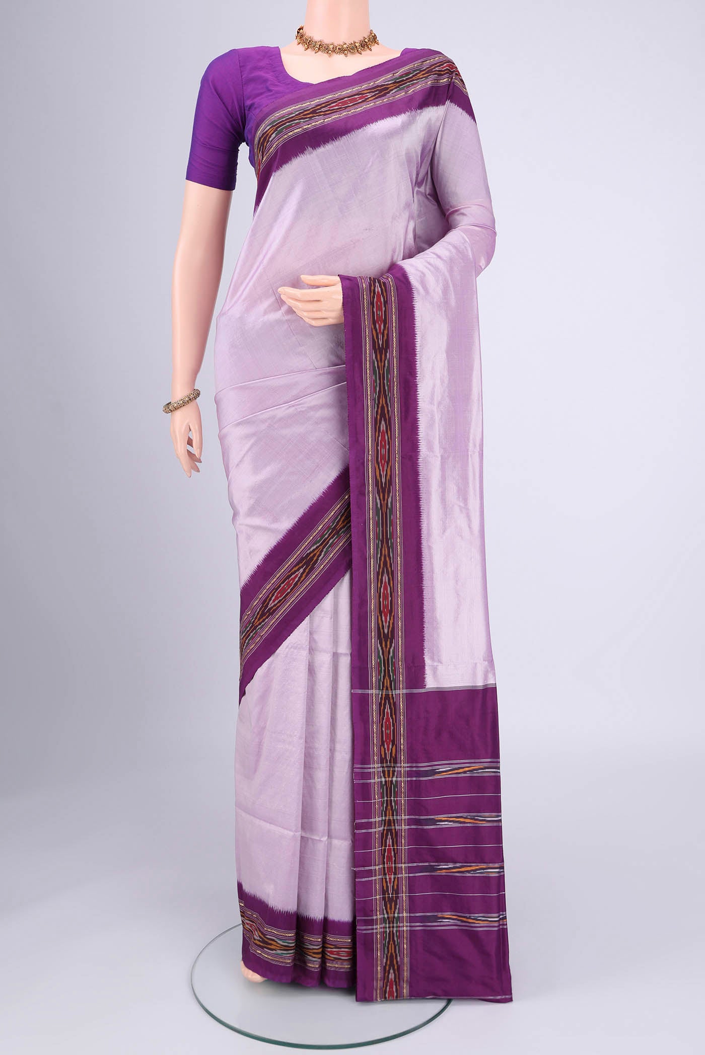 Lilac Pochampally Silk Saree with Plain Body and Ikat Border.  displayed on a mannequin