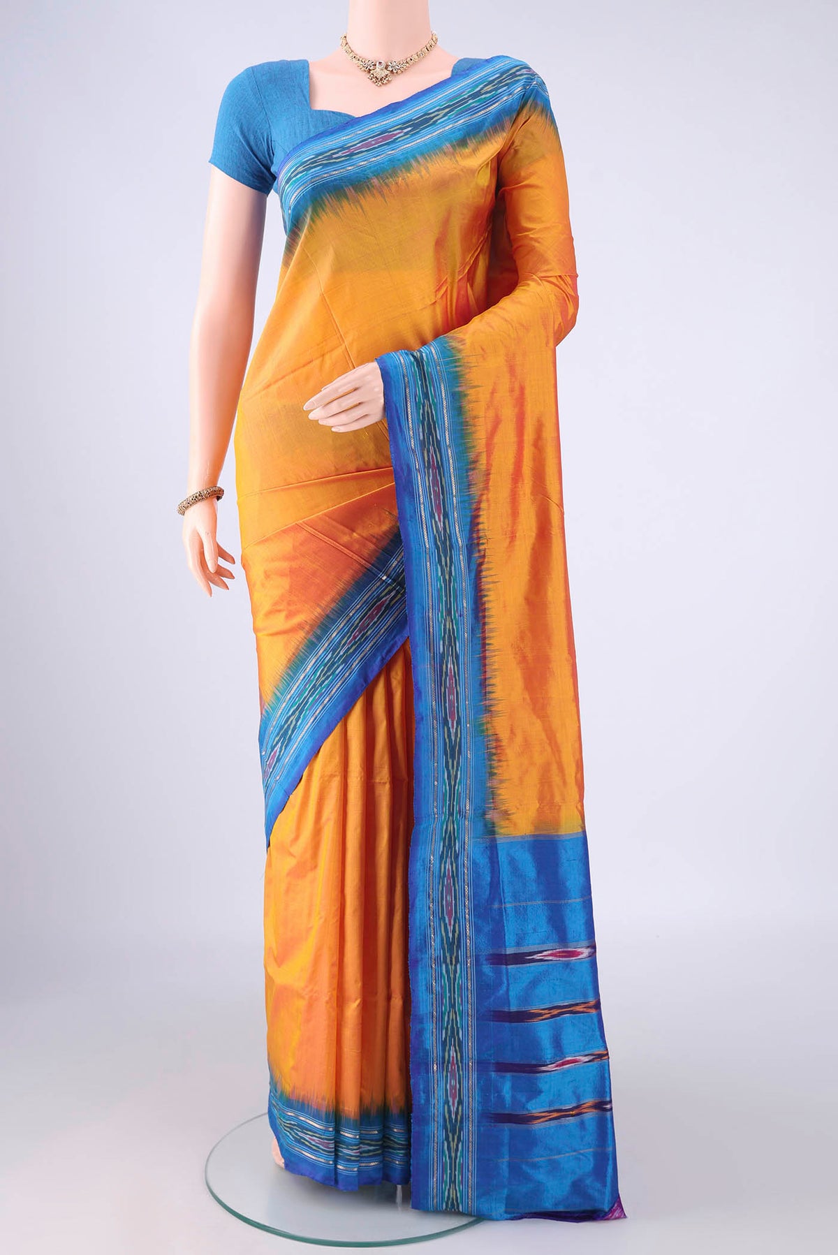Yellow Pochampally Silk Saree with Plain Body and Ikat Border.  displayed on a mannequin