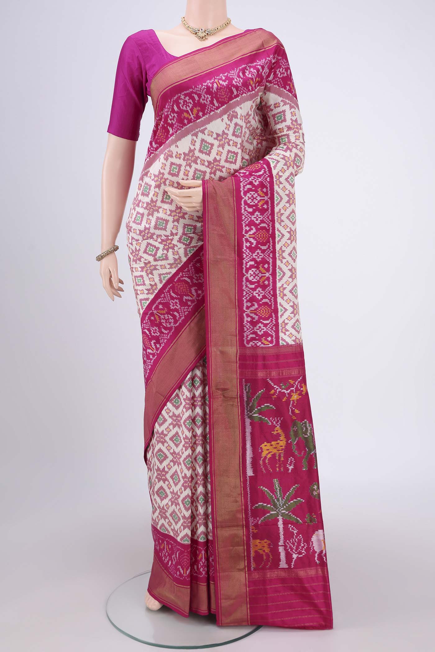 Off White Pochampally Silk Saree with Ikat design on the body and Zari Border.  displayed on a mannequin