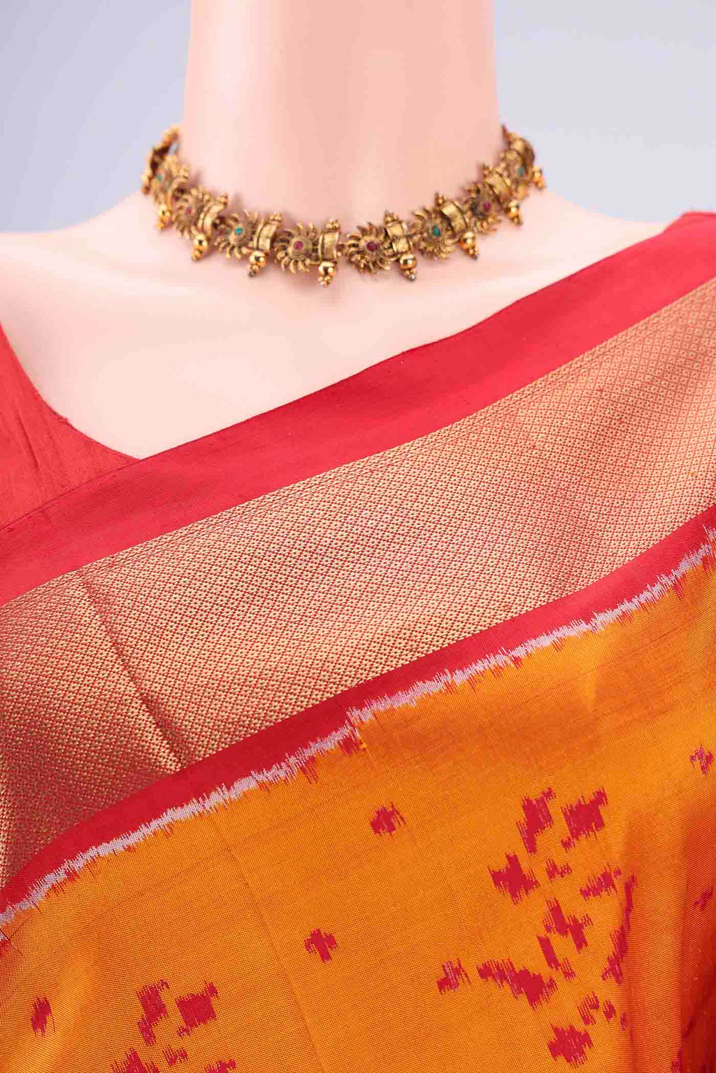 Border image of Orange Pochampally Silk Saree with Ikat design on the body and Zari Border. 