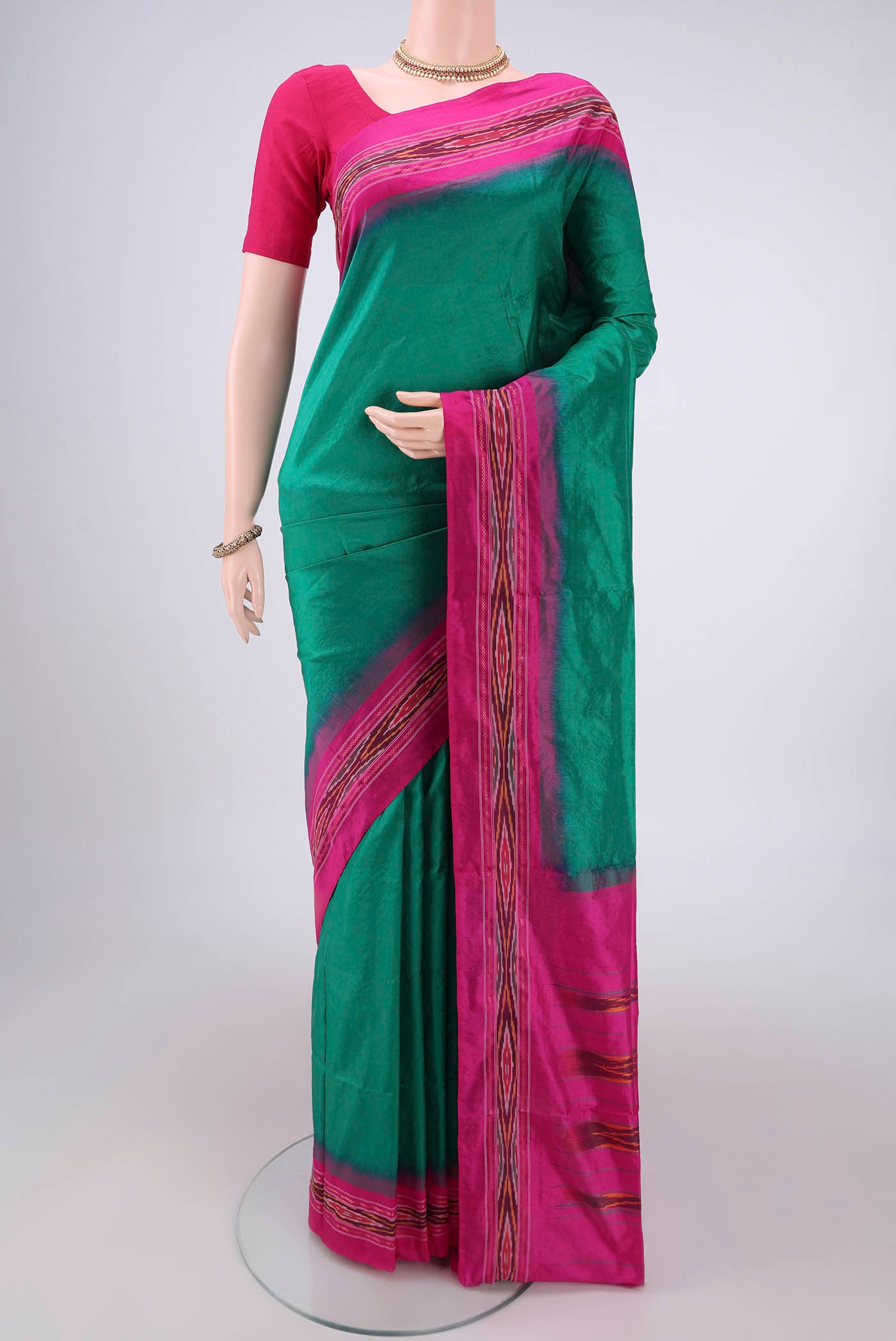 Green Pochampally Silk Saree with Plain Body and Ikat Border.  displayed on a mannequin