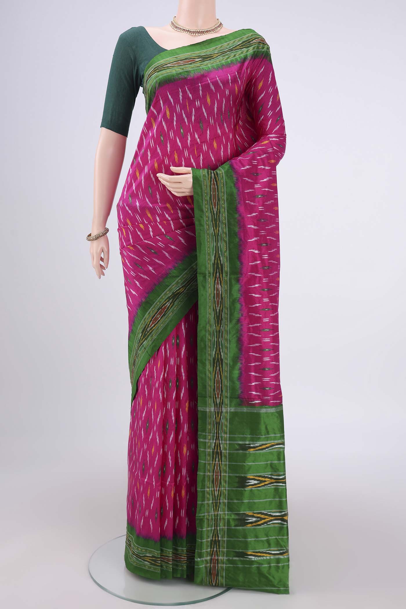 Rani Pink Pochampally Silk Saree with Ikat design on the body and Plain Border.  displayed on a mannequin