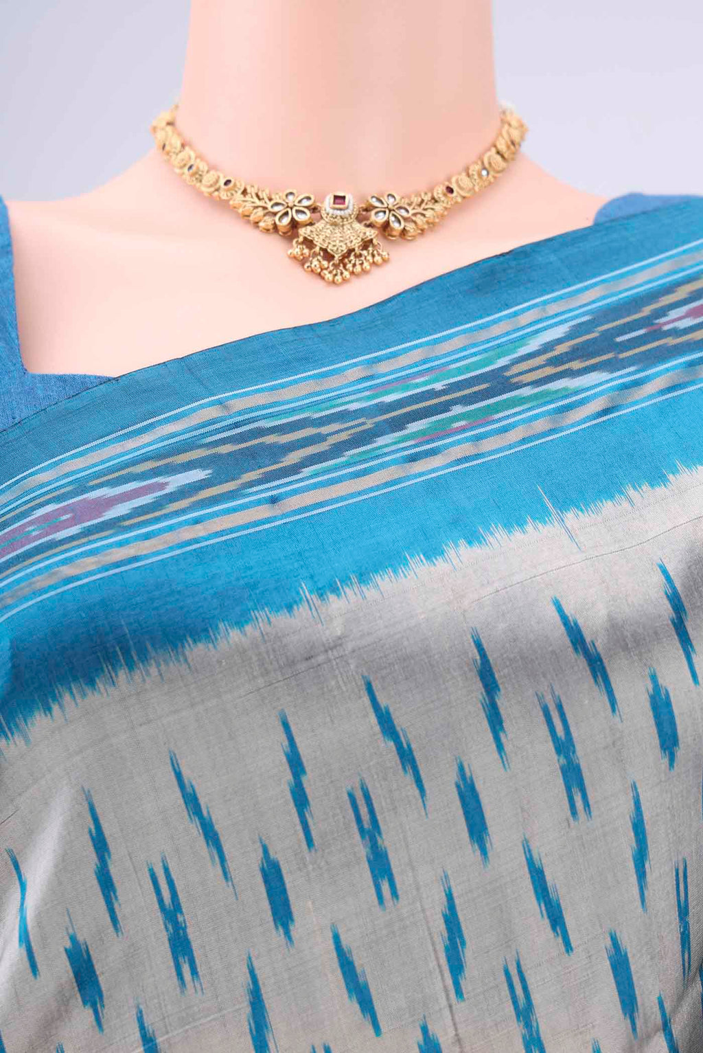 Border image of Grey Pochampally Silk Saree with Ikat design on the body and Zari Border. 