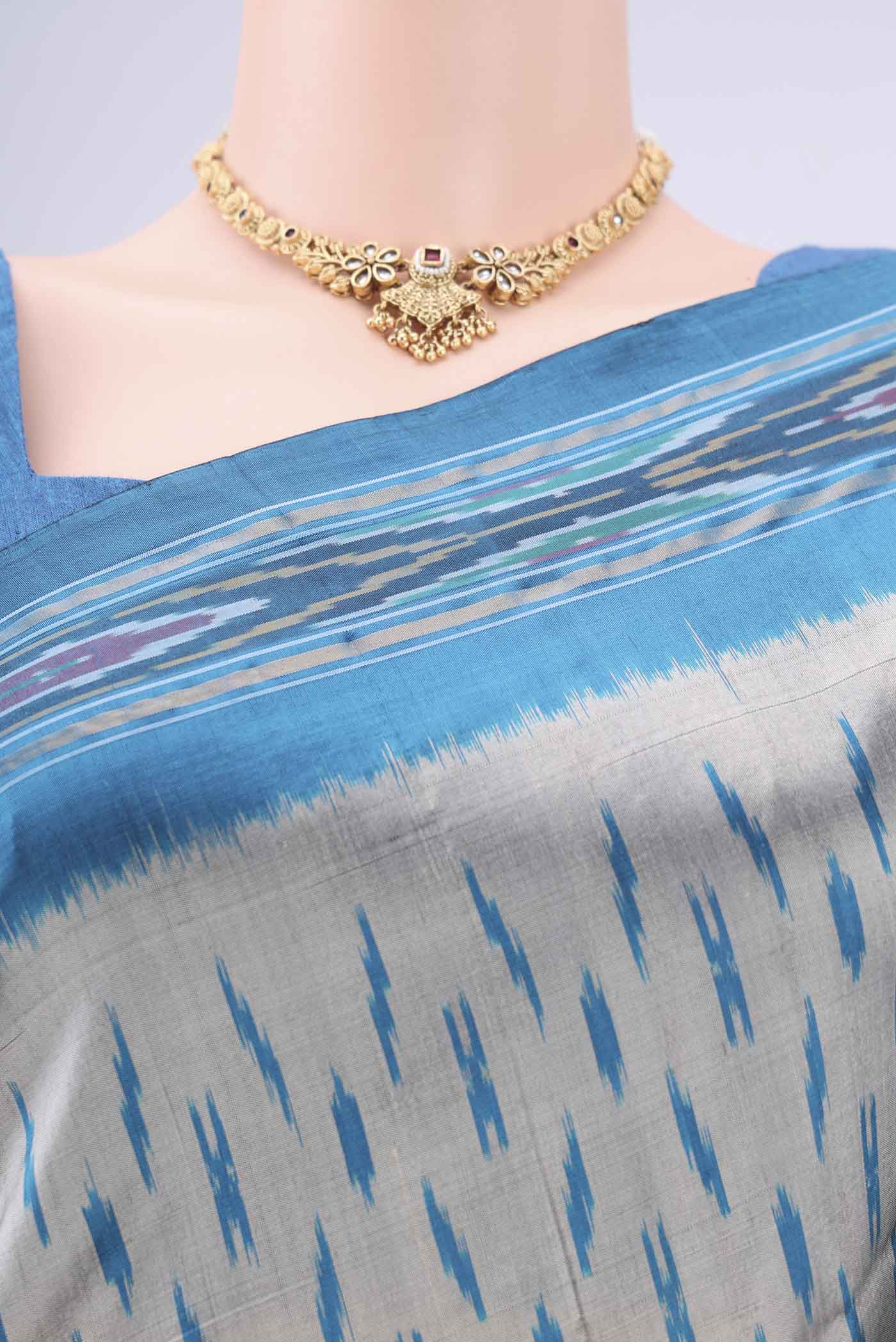 Border image of Grey Pochampally Silk Saree with Ikat design on the body and Zari Border. 