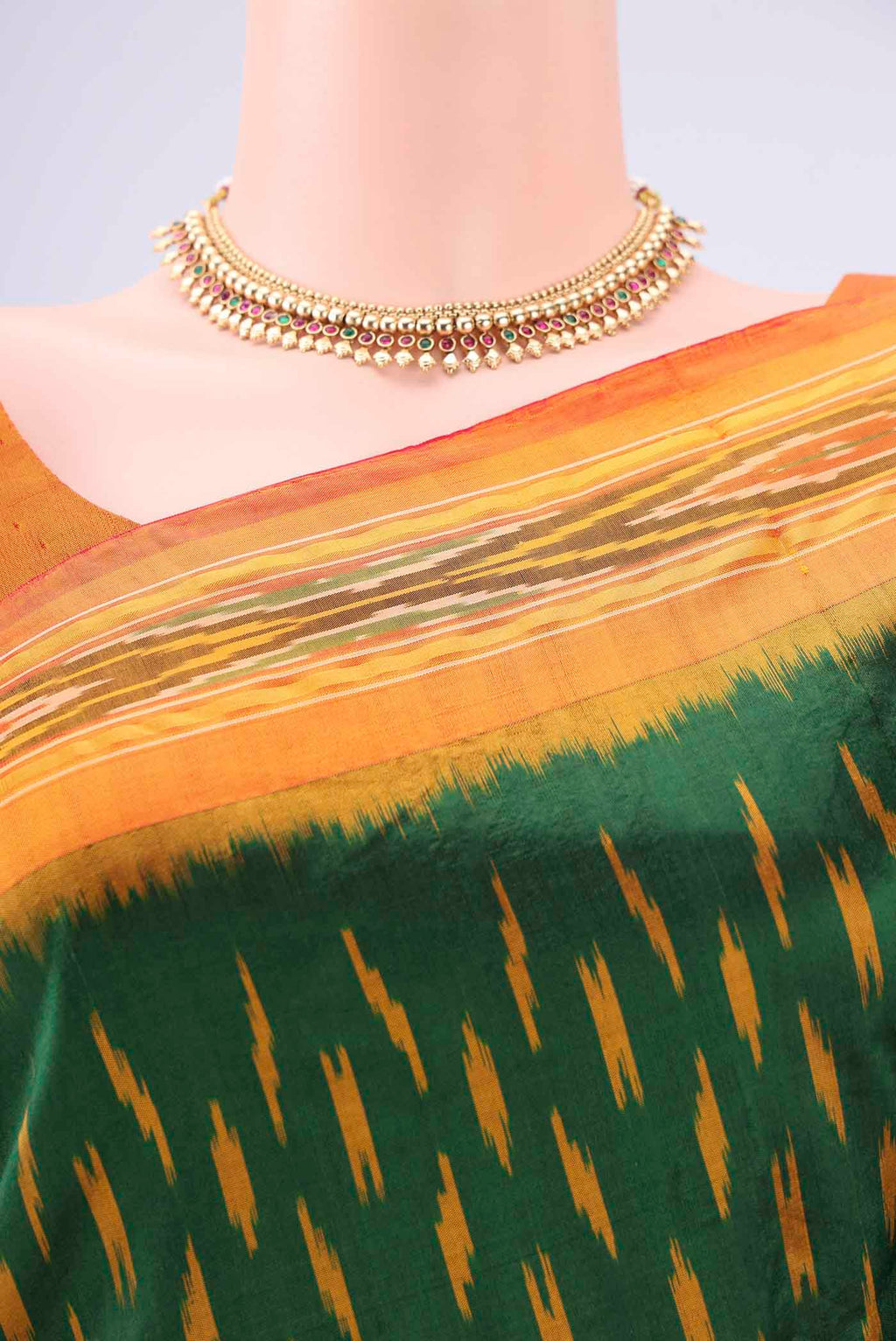 Border image of Bottle Green Pochampally Silk Saree with Checked design on the body and Ikat Border. 