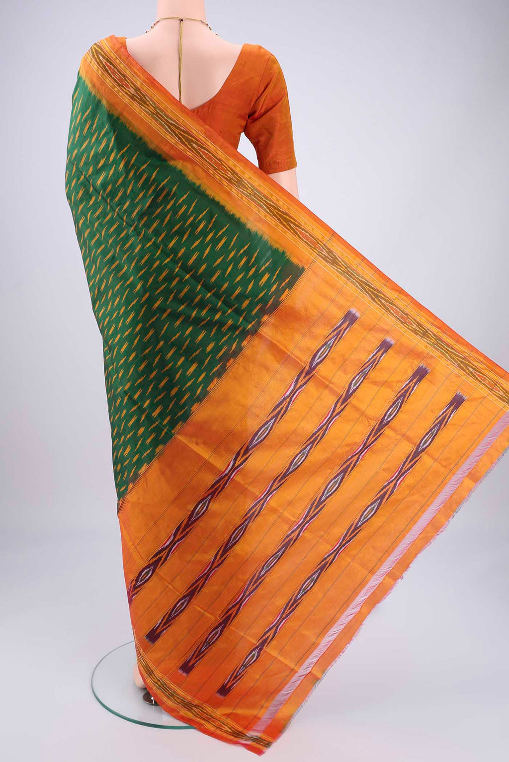Flat view of Bottle Green Pochampally Silk Saree with Checked design on the body and Ikat Border. 