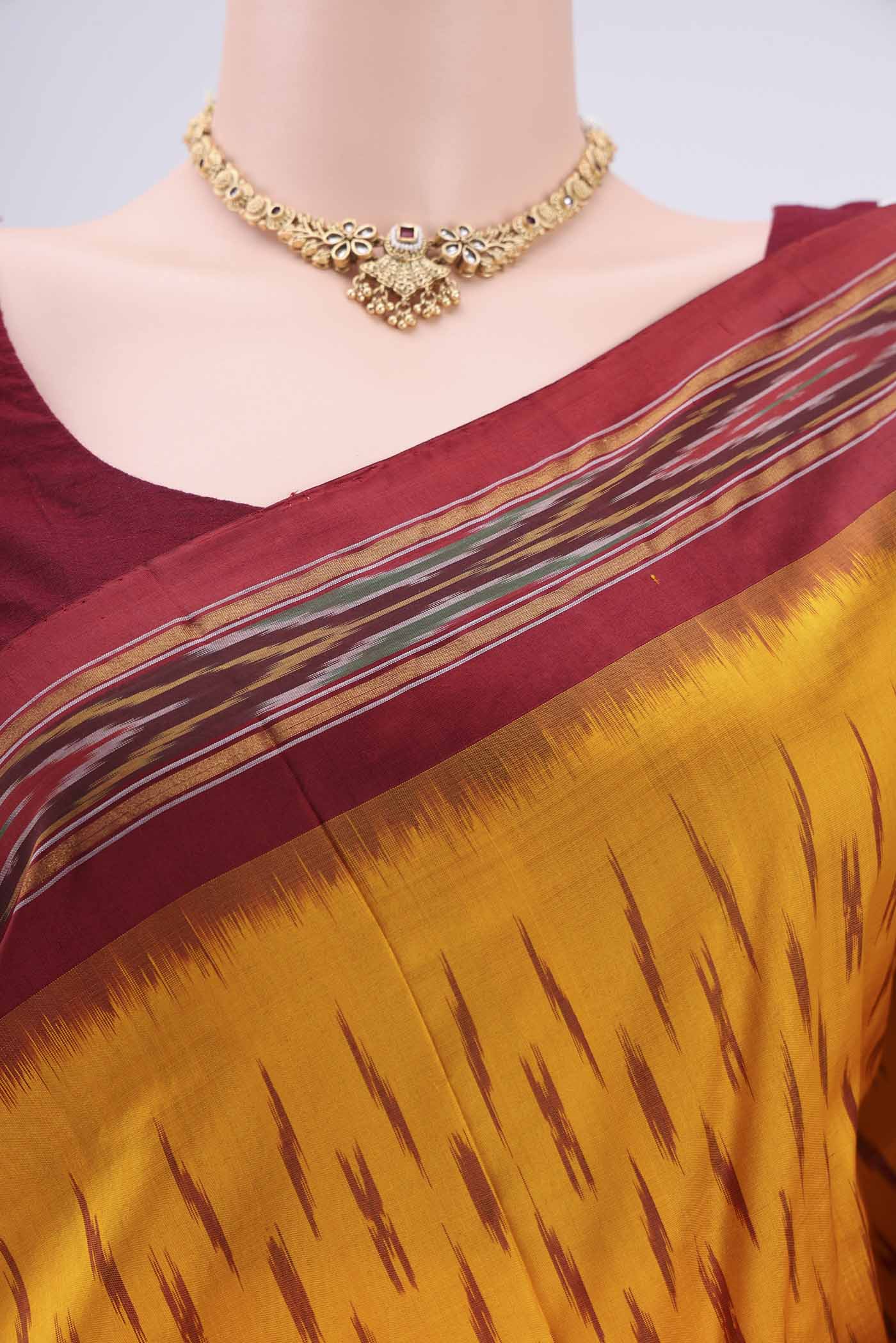 Border image of Yellow Pochampally Silk Saree with Ikat design on the body and Plain Border. 