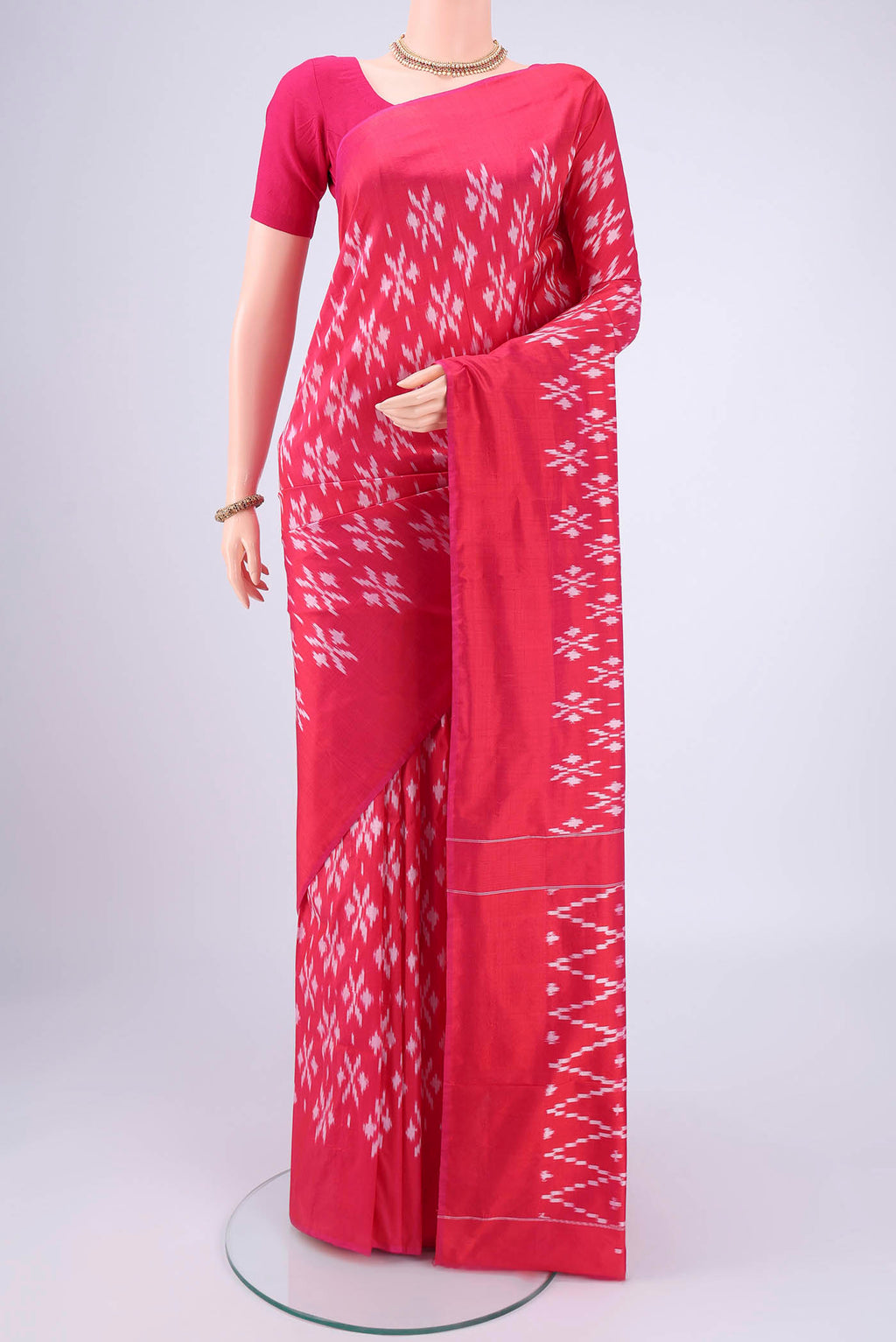 Rani Pink Pochampally Silk Saree with Checked design on the body and Plain Border.  displayed on a mannequin