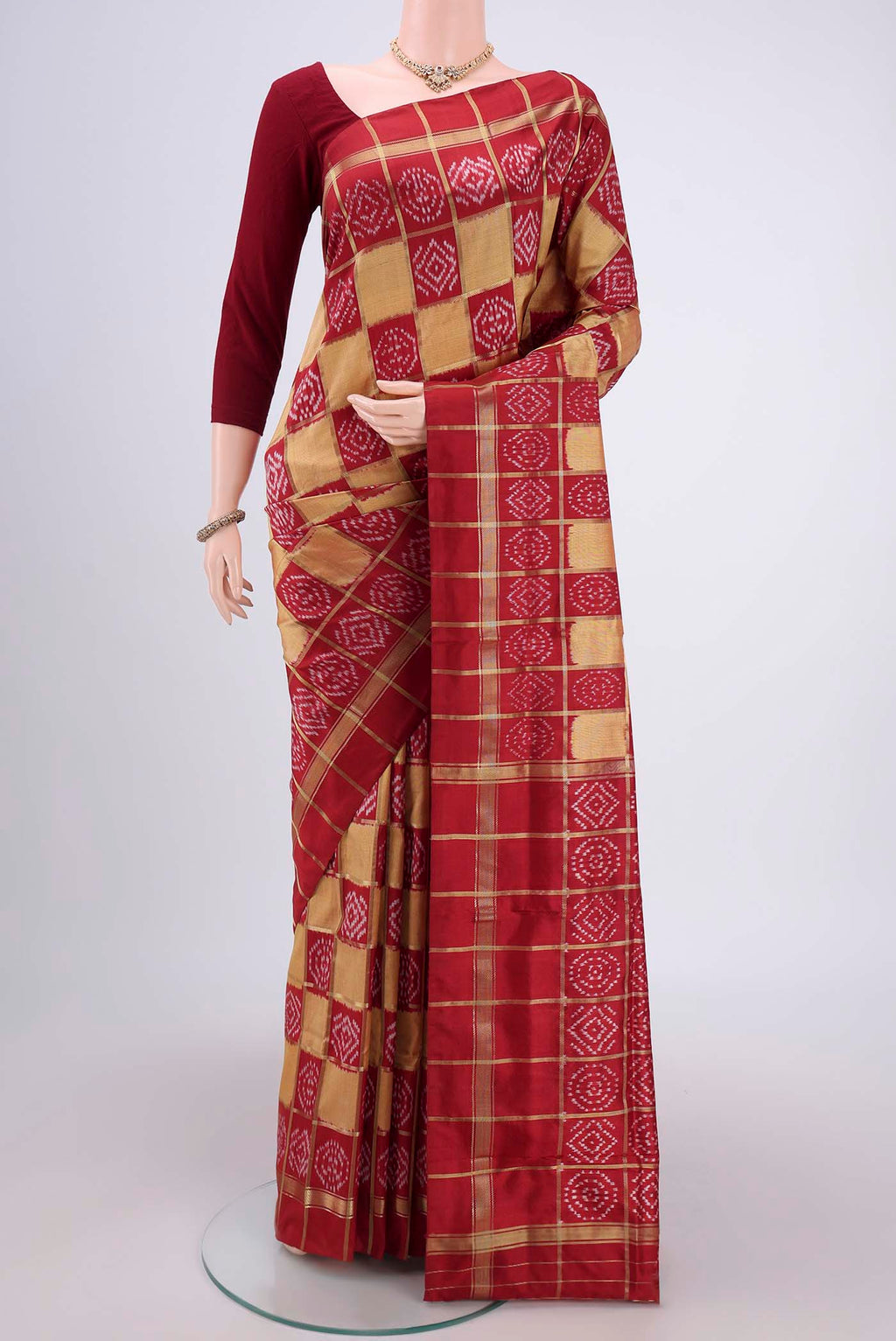Peach Pochampally Silk Saree with Checked design on the body and Zari Border.  displayed on a mannequin