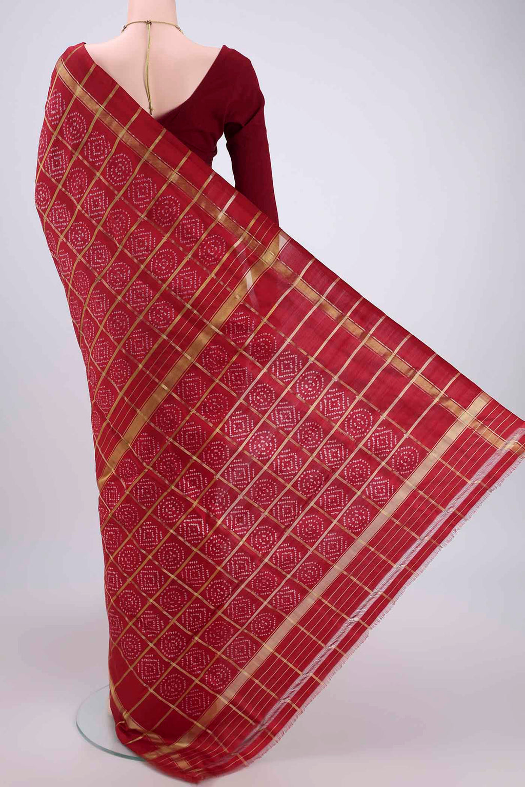 Flat view of Maroon Pochampally Silk Saree with Checked design on the body and Zari Border. 
