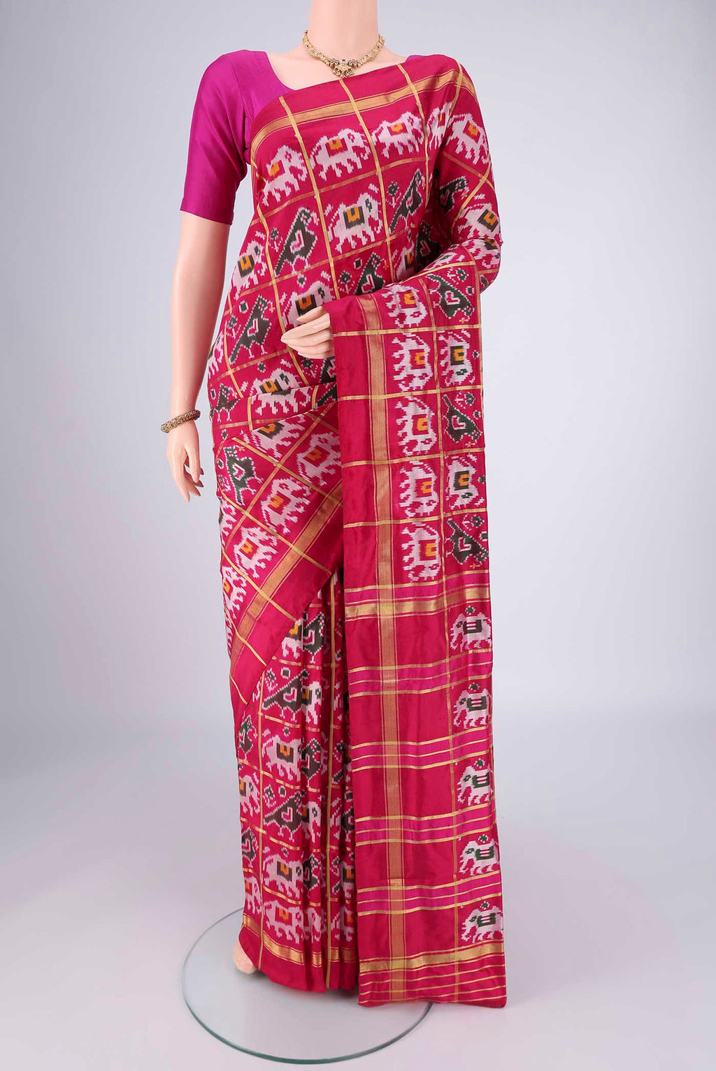 Rani Pink Pochampally Silk Saree with Checked design on the body and Plain Border.  displayed on a mannequin