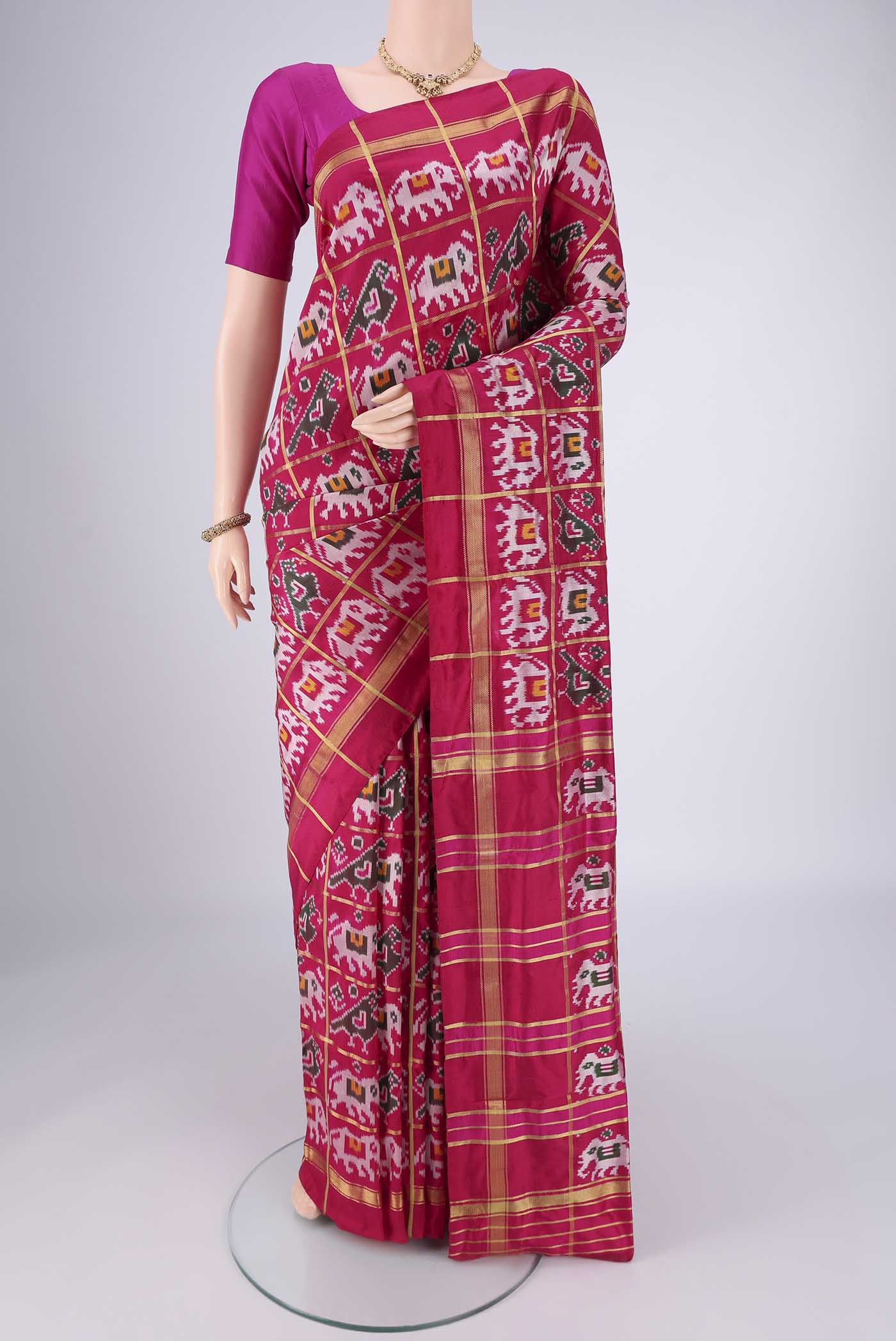 Rani Pink Pochampally Silk Saree with Checked design on the body and Plain Border.  displayed on a mannequin
