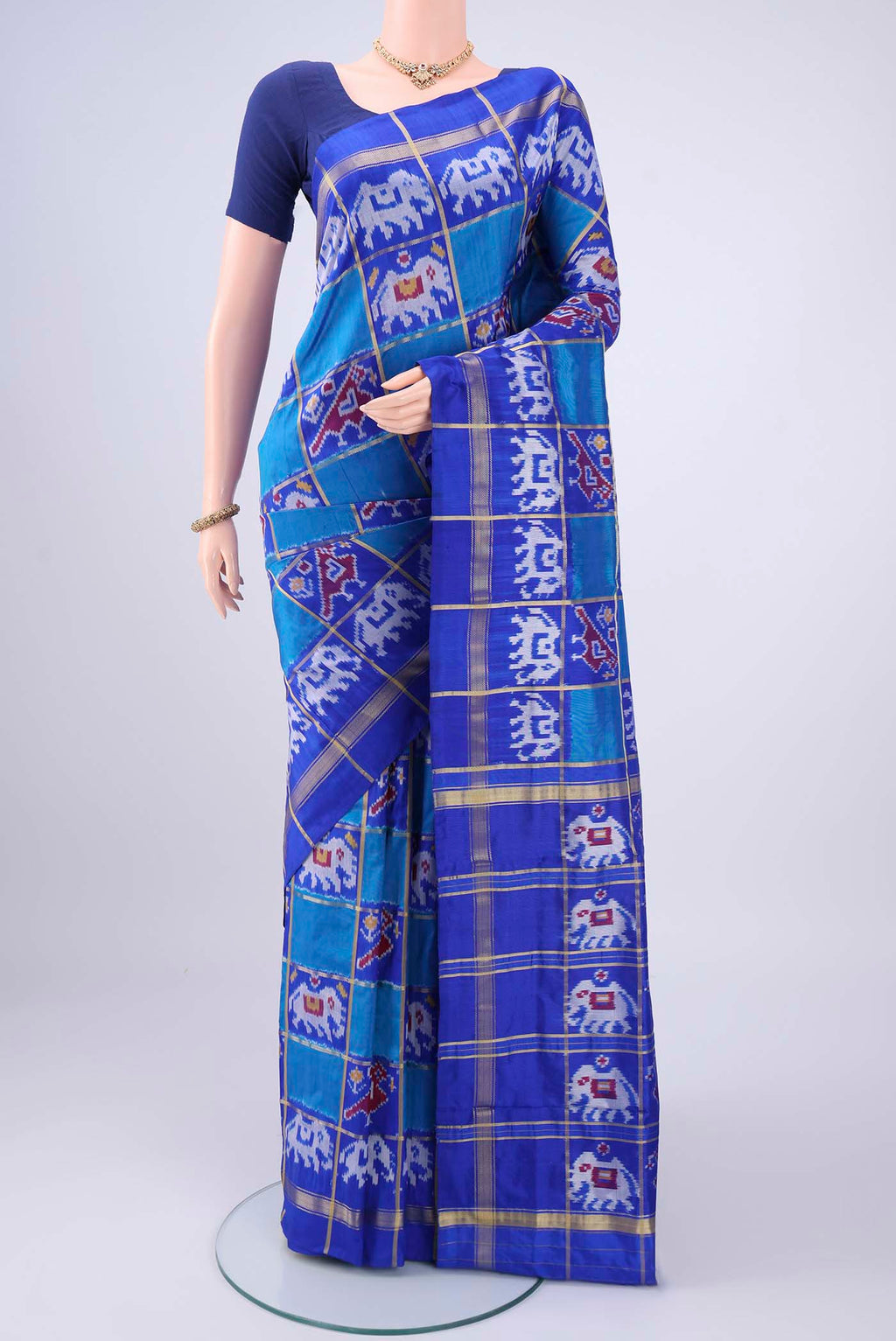Multi Color Pochampally Silk Saree with Checked design on the body and Zari Border.  displayed on a mannequin