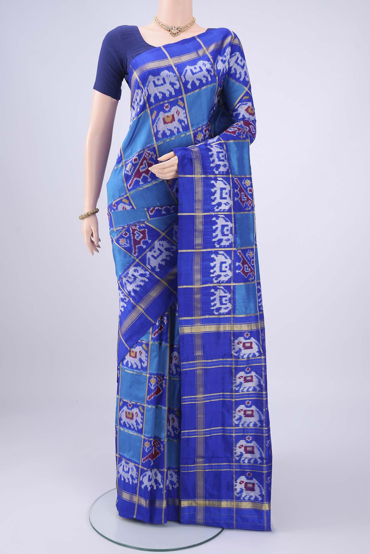 Multi Color Pochampally Silk Saree with Checked design on the body and Zari Border.  displayed on a mannequin