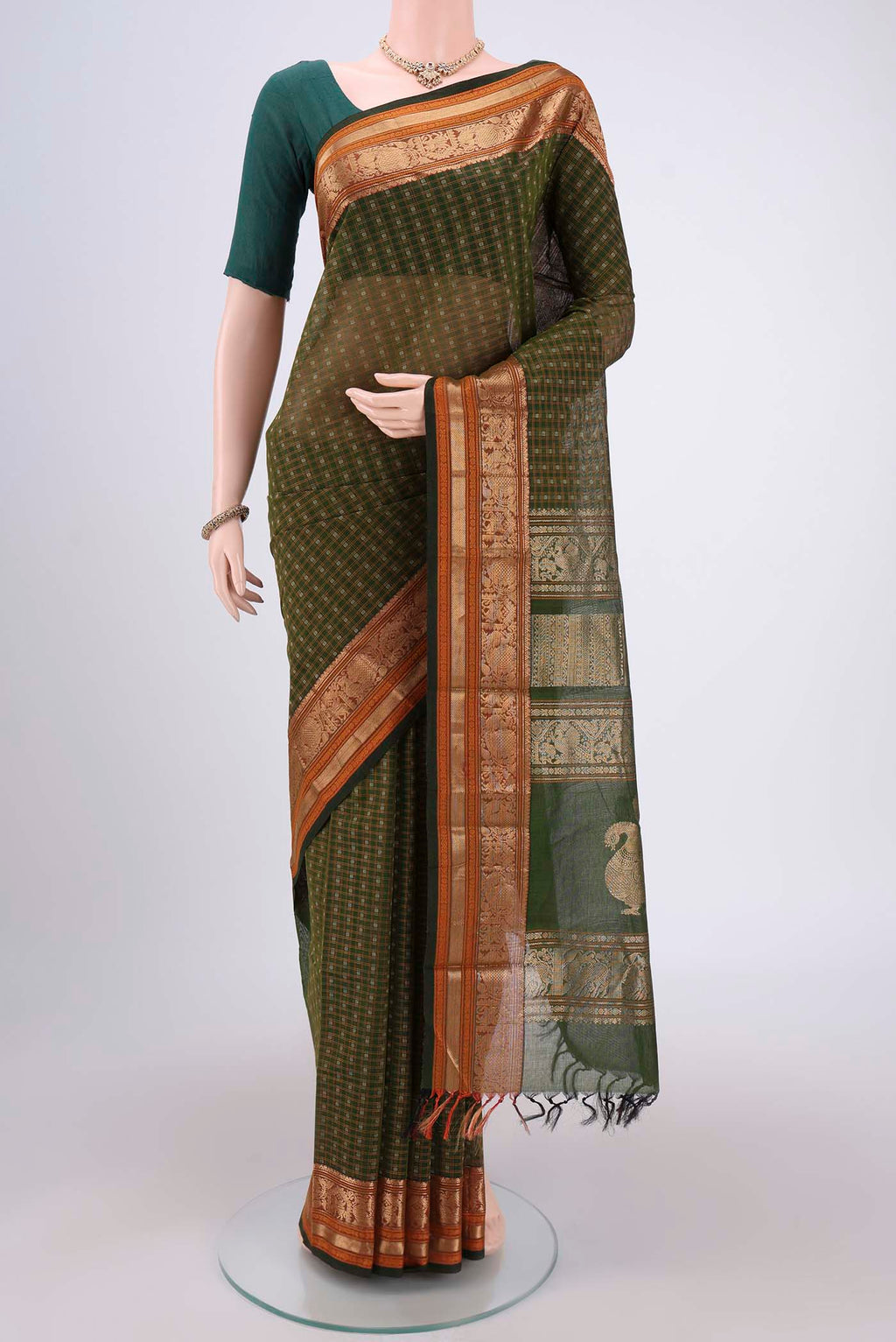 Bottle Green Kanchi Cotton Saree with Checked design on the body and Zari Border.  displayed on a mannequin
