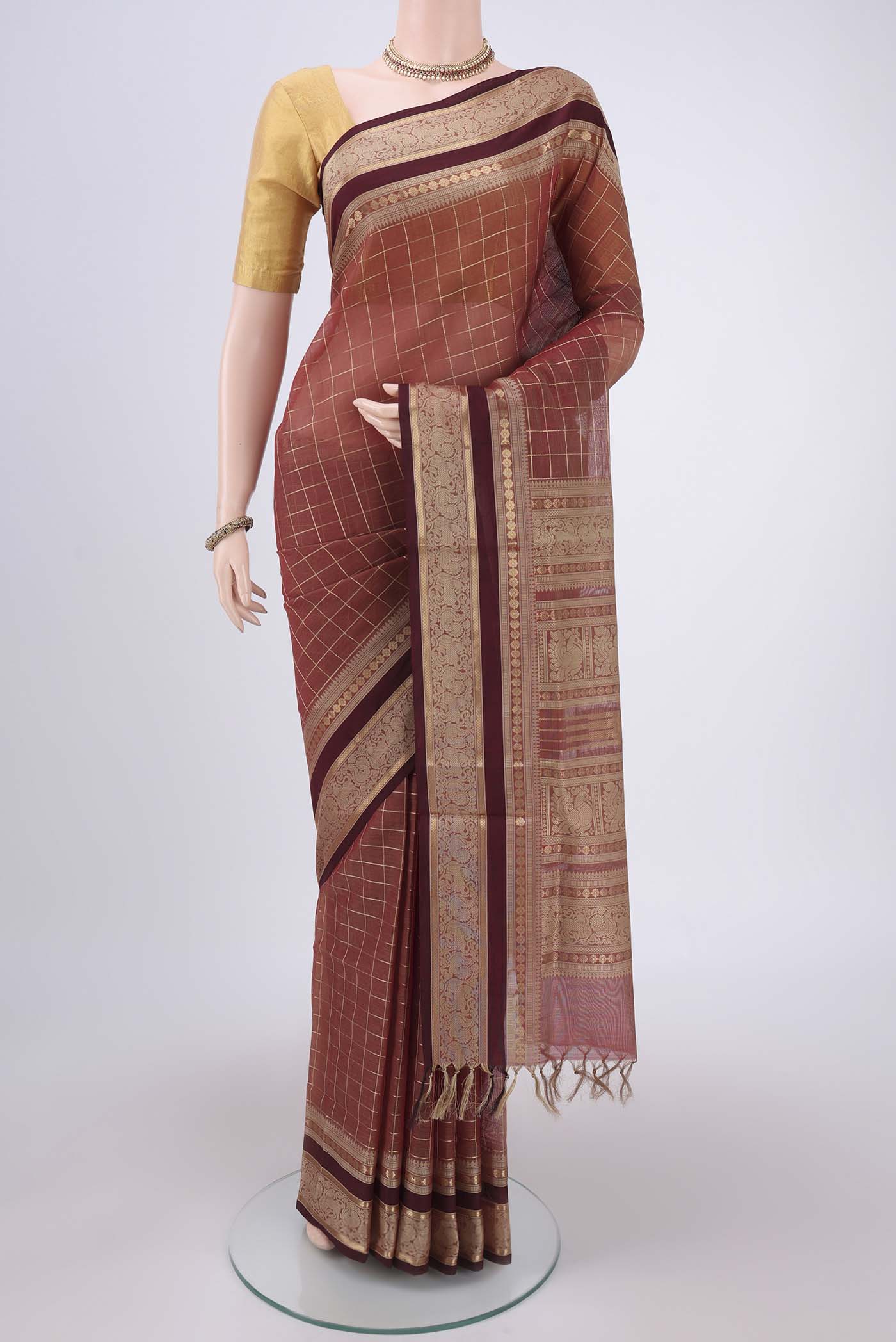 Brown Kanchi Cotton Saree with Checked design on the body and Zari Border.  displayed on a mannequin