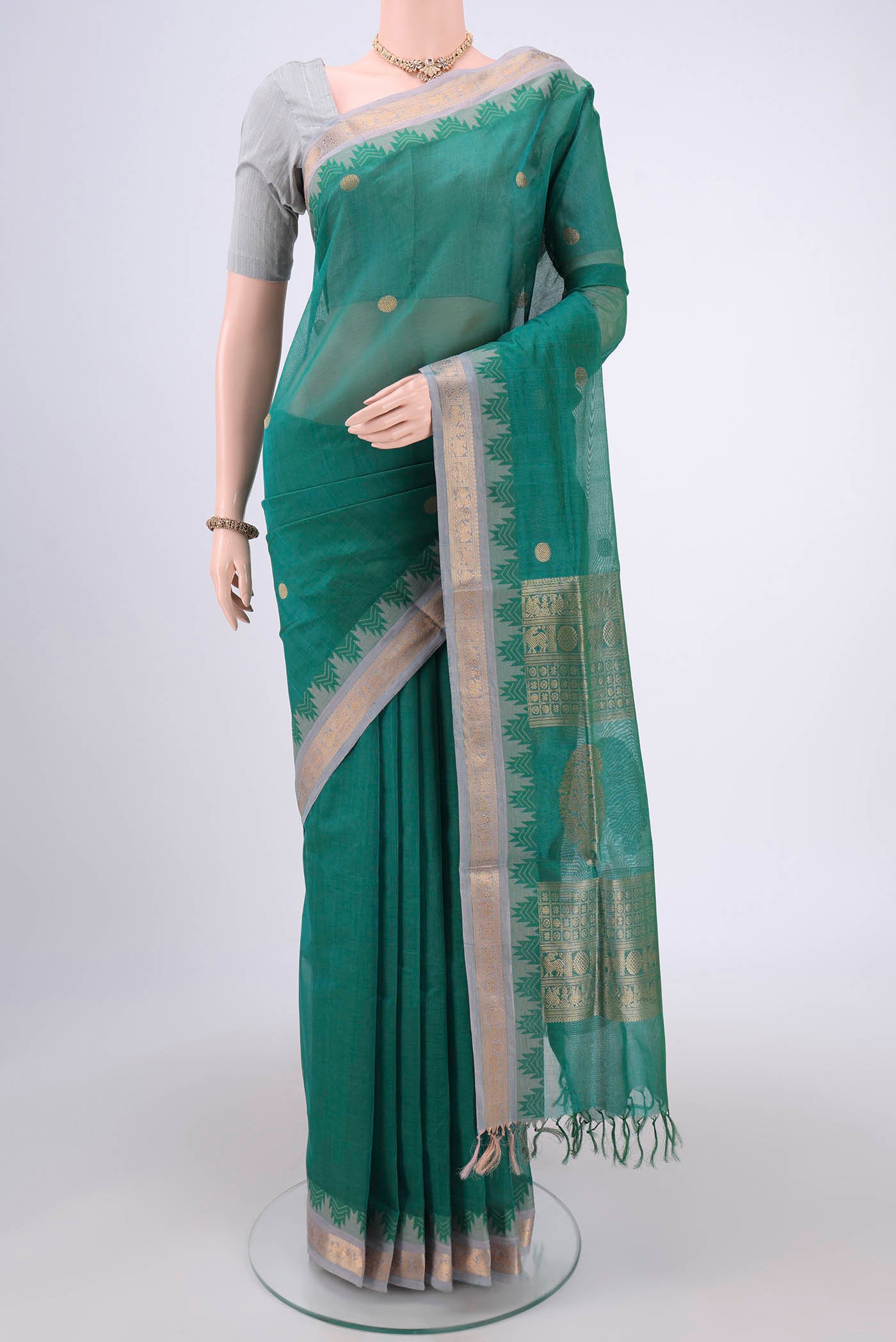 Sea Green Coimbatore Silk Cotton Saree with Zari Butta on the body and Zari Border.  displayed on a mannequin