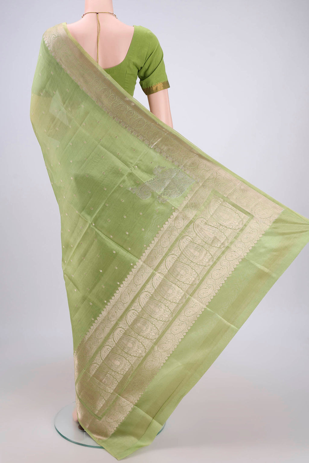 Flat view of Light Green Banarasi Raw Silk Saree with Zari Butta on the body and Zari Border. 