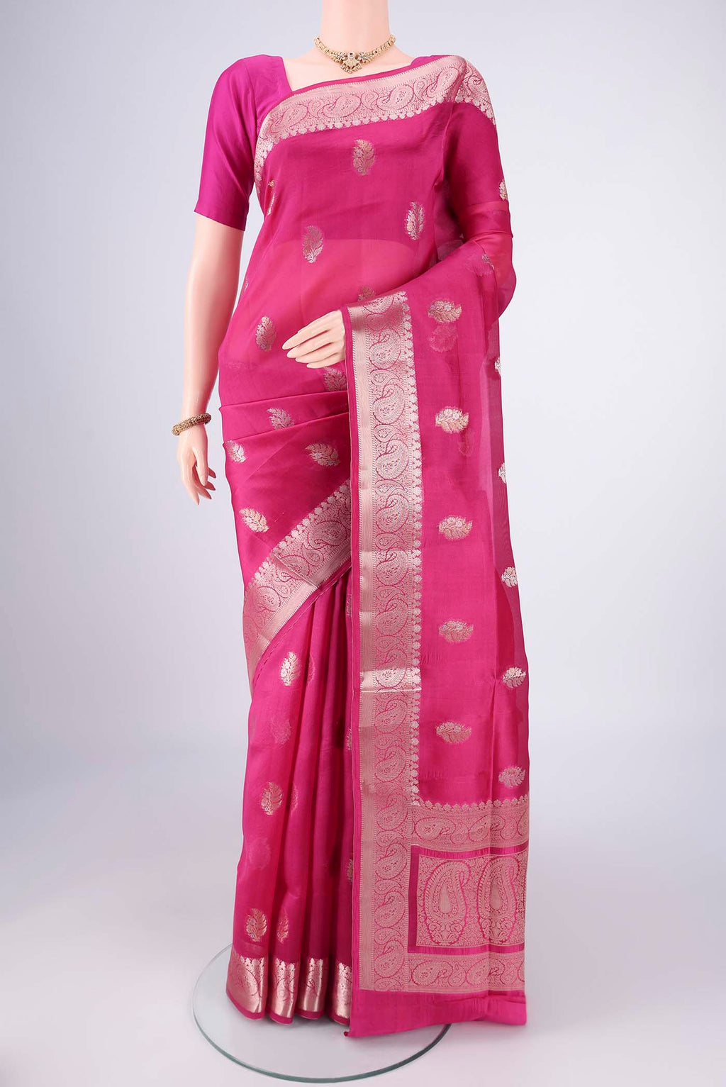 Dark Pink Banarasi Raw Silk Saree with Zari Butta on the body and Zari Border.  displayed on a mannequin