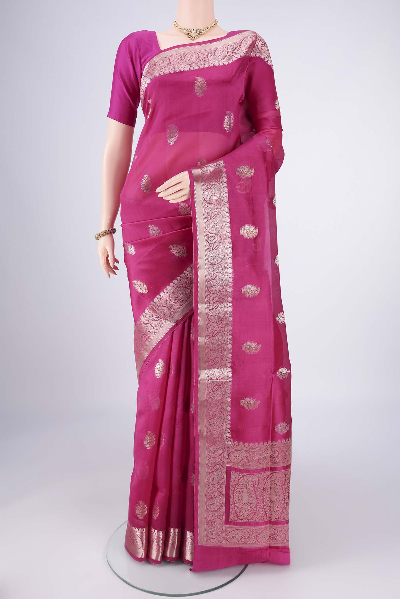 Dark Pink Banarasi Raw Silk Saree with Zari Butta on the body and Zari Border.  displayed on a mannequin