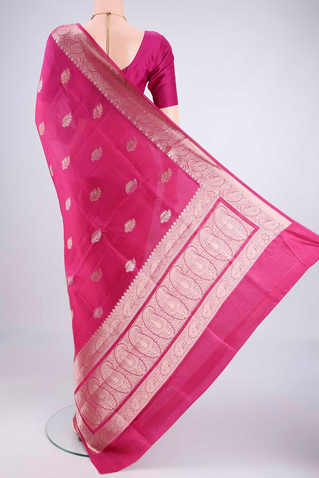 Flat view of Dark Pink Banarasi Raw Silk Saree with Zari Butta on the body and Zari Border. 