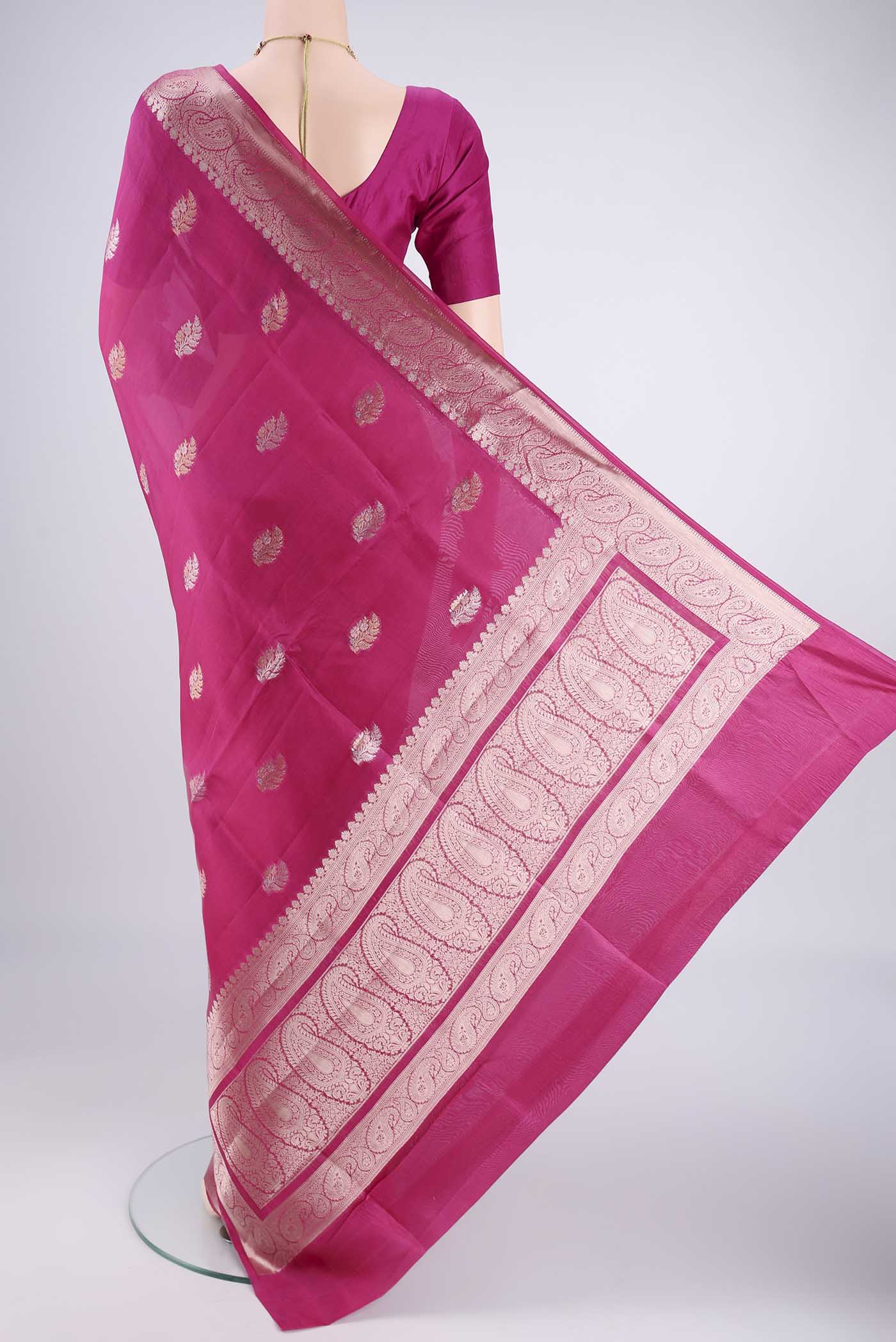Flat view of Dark Pink Banarasi Raw Silk Saree with Zari Butta on the body and Zari Border. 