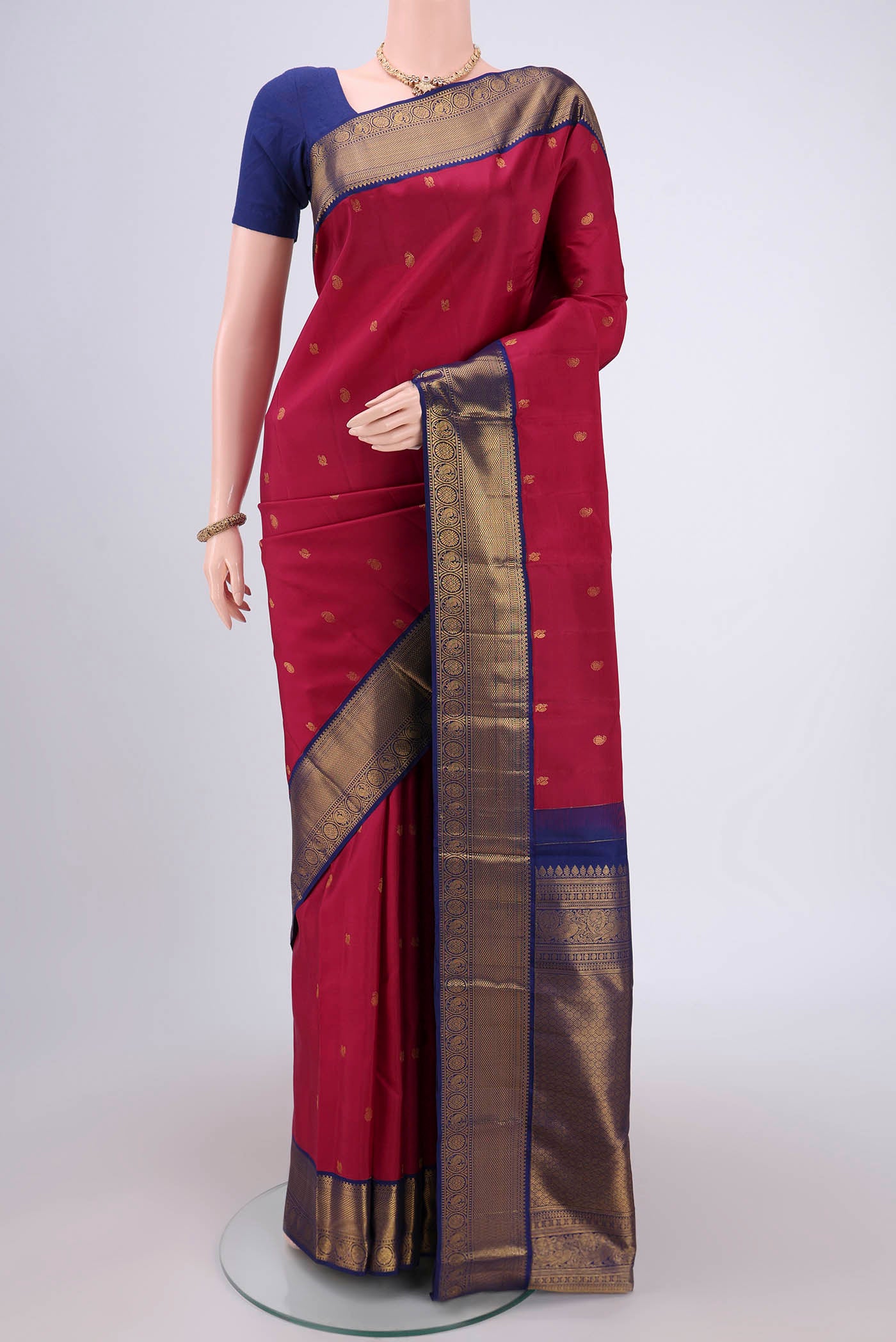 Dark Pink Kanjivaram Silk Saree with Zari Butta on the body and Zari Border.  displayed on a mannequin