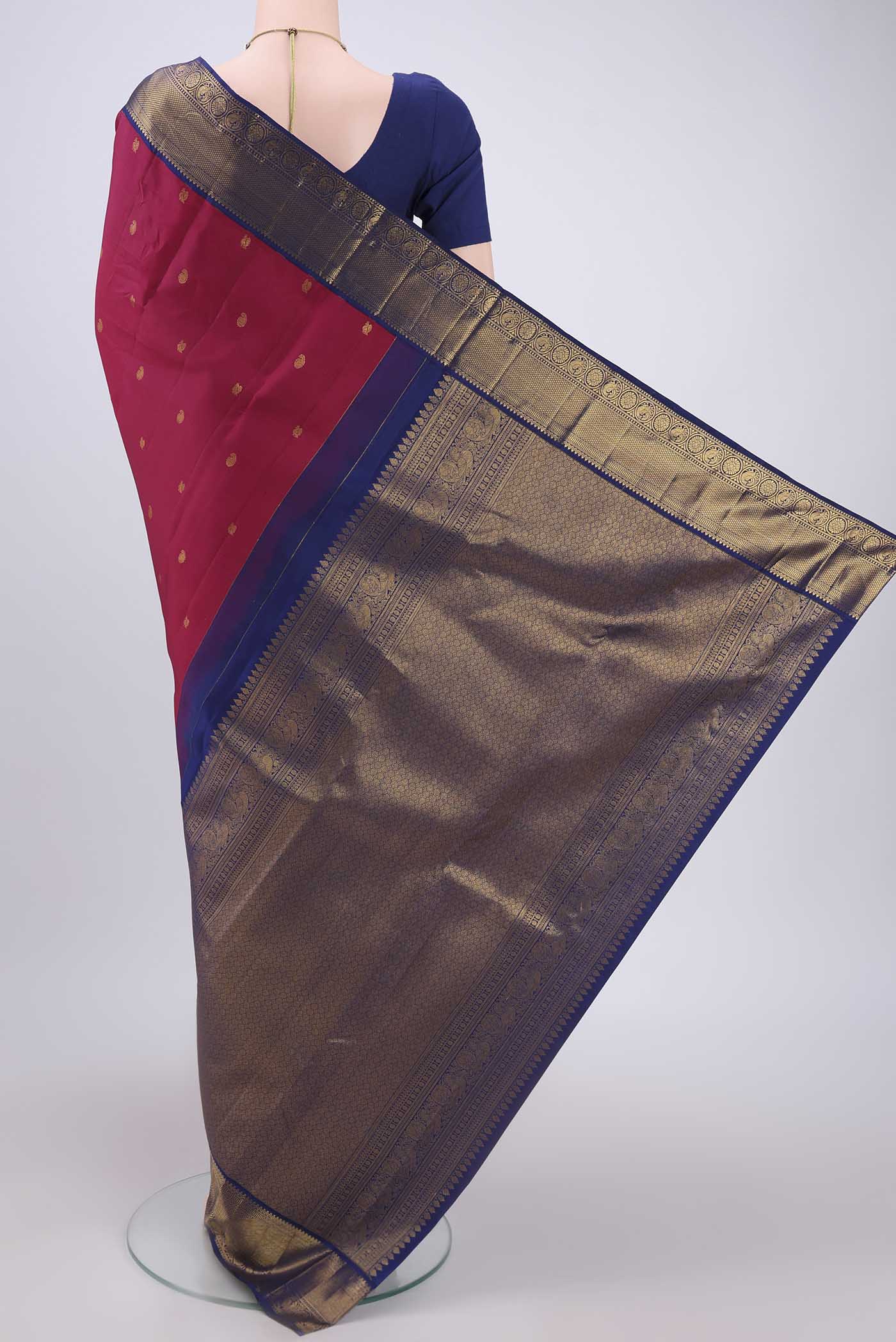 Flat view of Dark Pink Kanjivaram Silk Saree with Zari Butta on the body and Zari Border. 