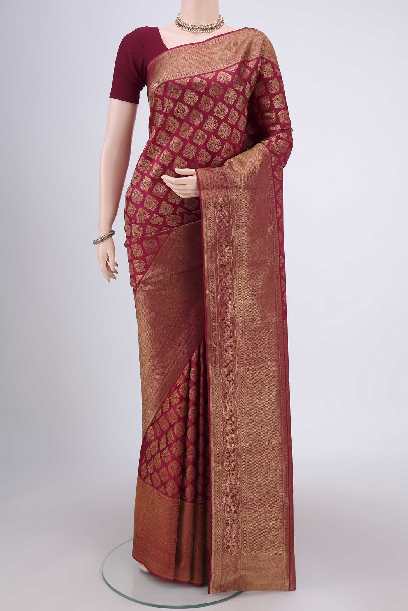 Maroon Kanjivaram Silk Saree with Zari Brocade on the body and Zari Border.  displayed on a mannequin
