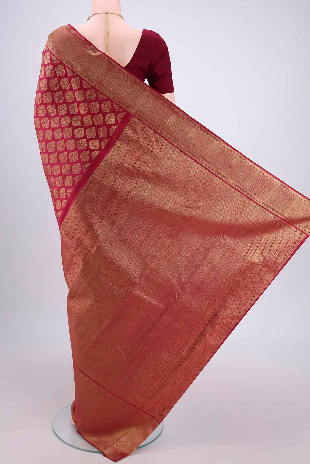 Flat view of Maroon Kanjivaram Silk Saree with Zari Brocade on the body and Zari Border. 