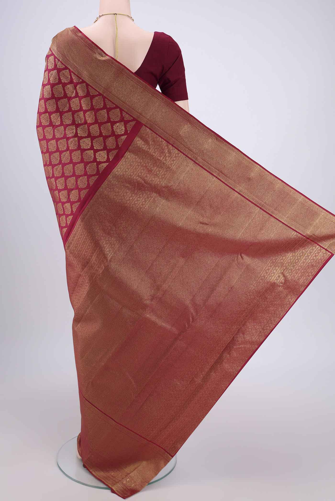 Flat view of Maroon Kanjivaram Silk Saree with Zari Brocade on the body and Zari Border. 