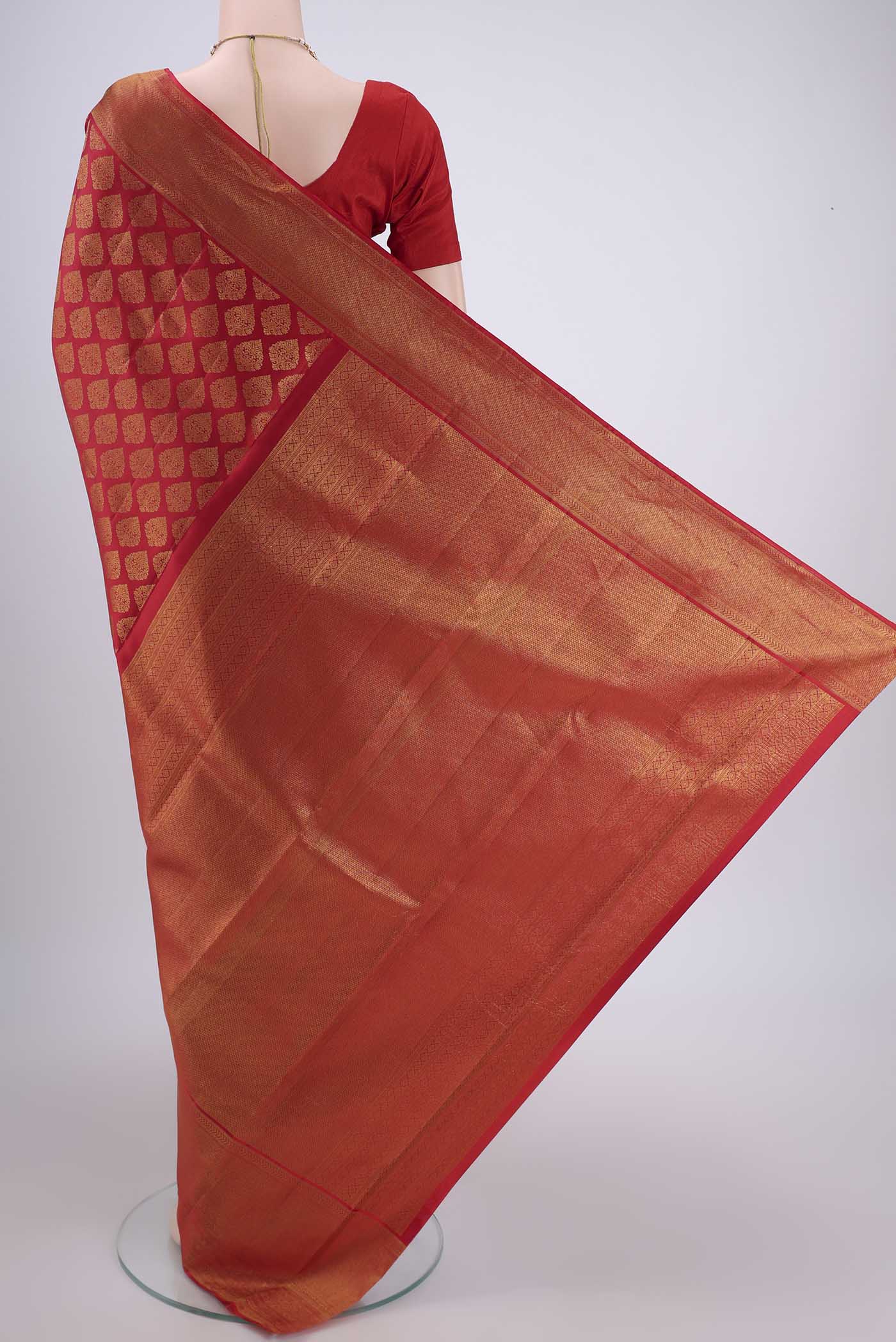 Flat view of Red Kanjivaram Silk Saree with Zari Brocade on the body and Zari Border. 